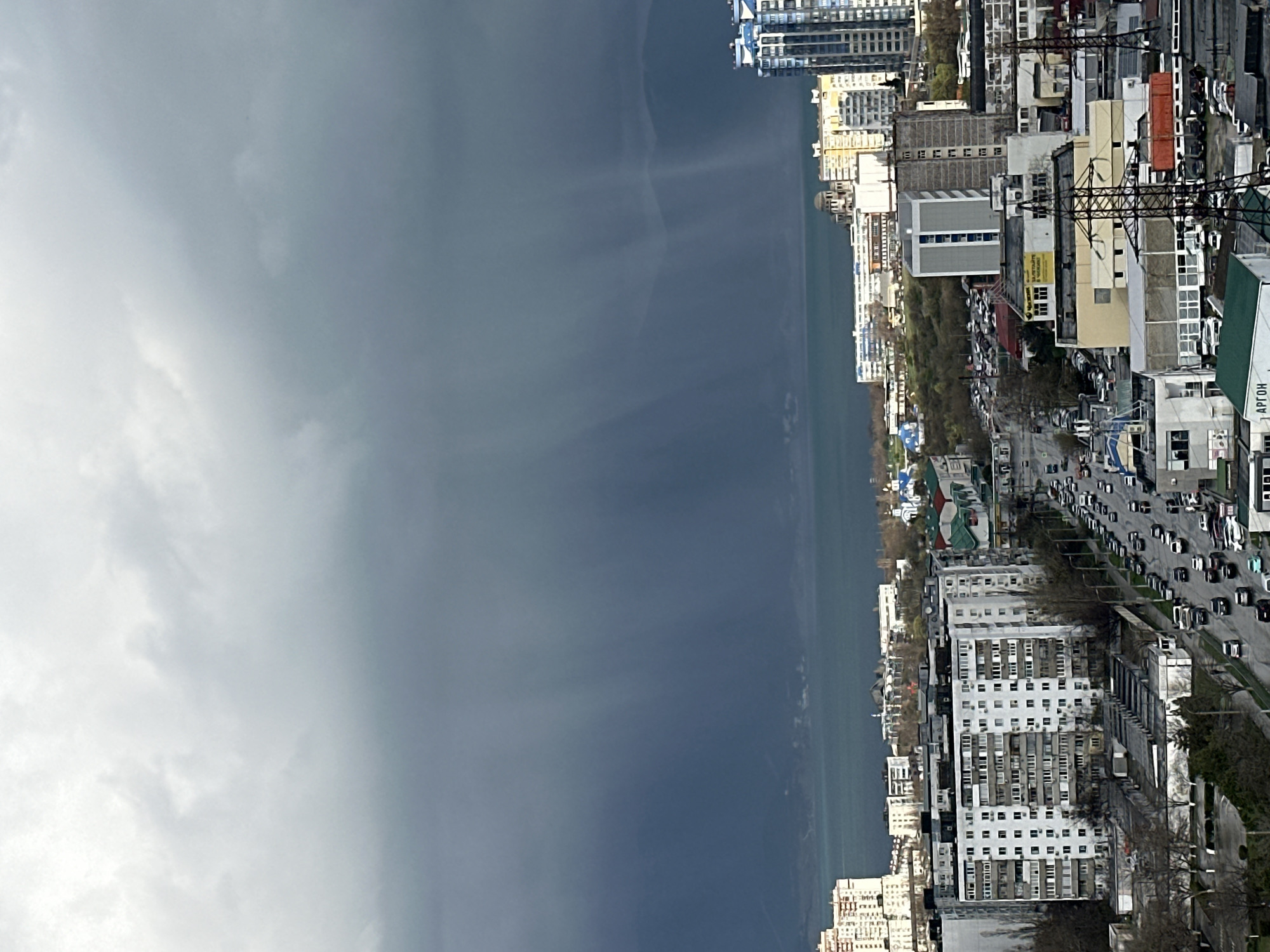 Cloudy coastal cityscape captured by unknown witness