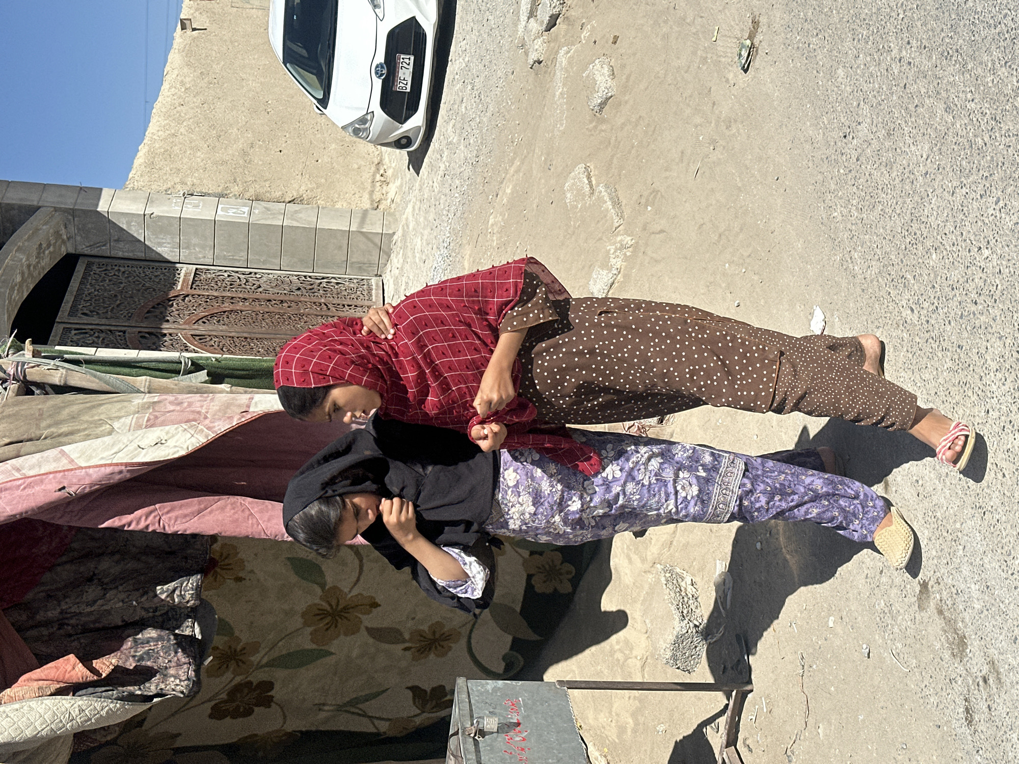 Two women walk together in Quetta semi-urban area