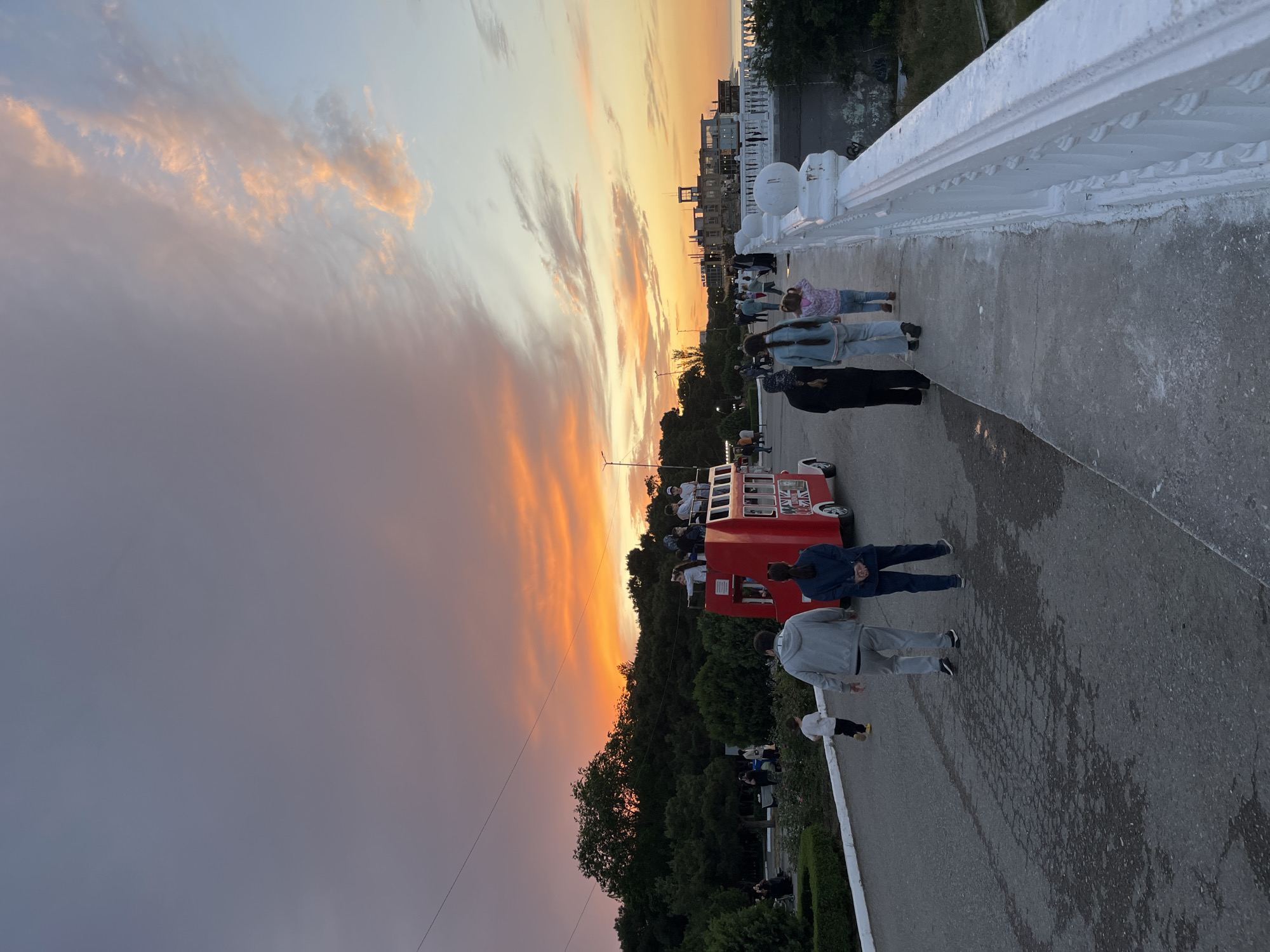 Evening stroll captured on Kaspiysk waterfront bridge at sunset