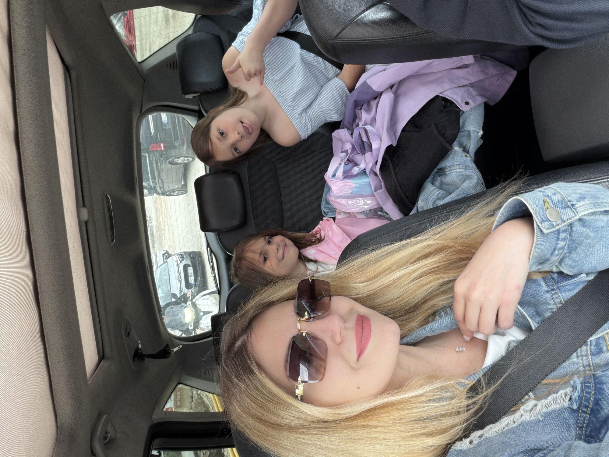 Woman and two girls travel by car in Montenegro