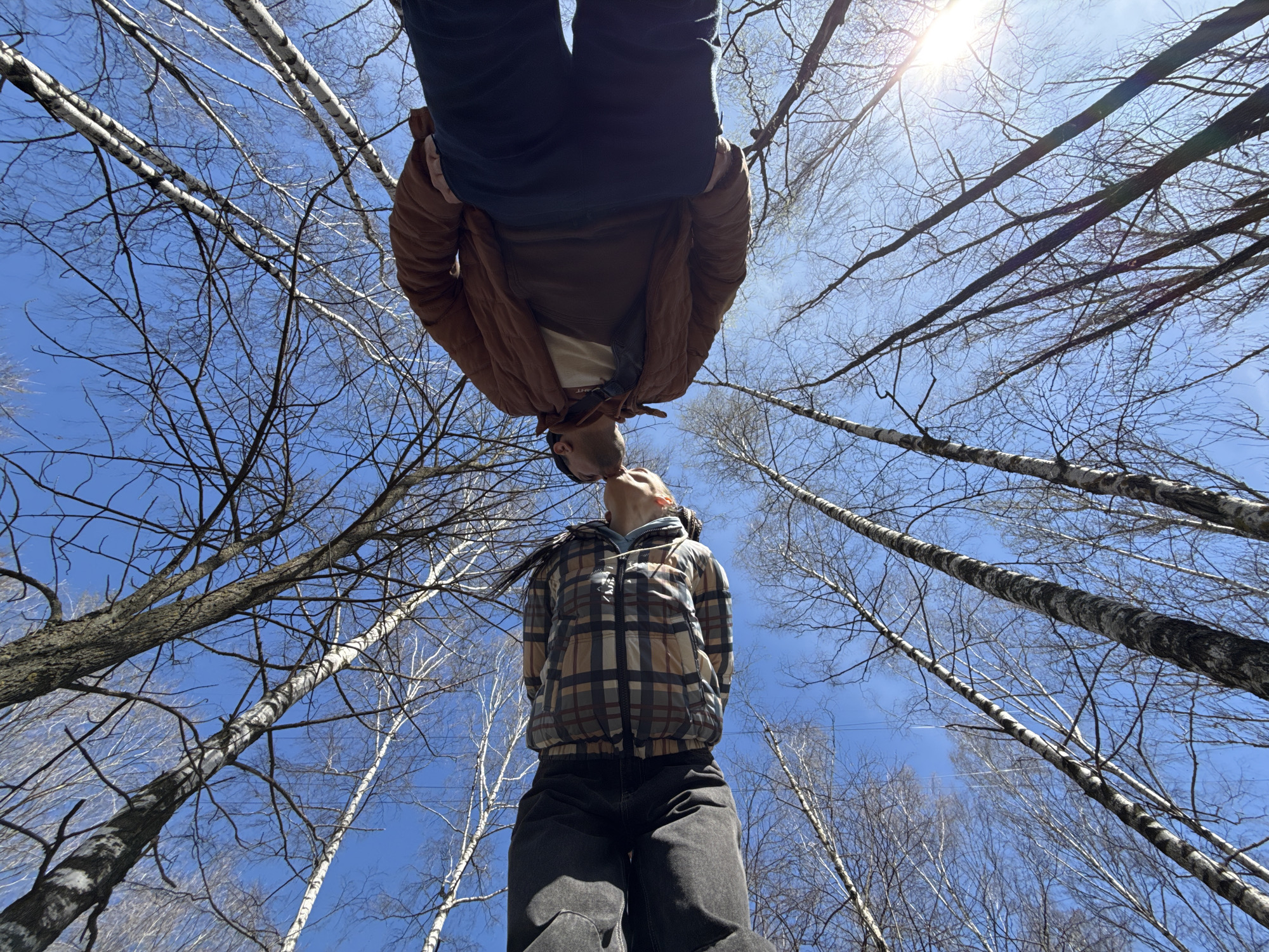 Couple shares playful moment in Rusanovo forest