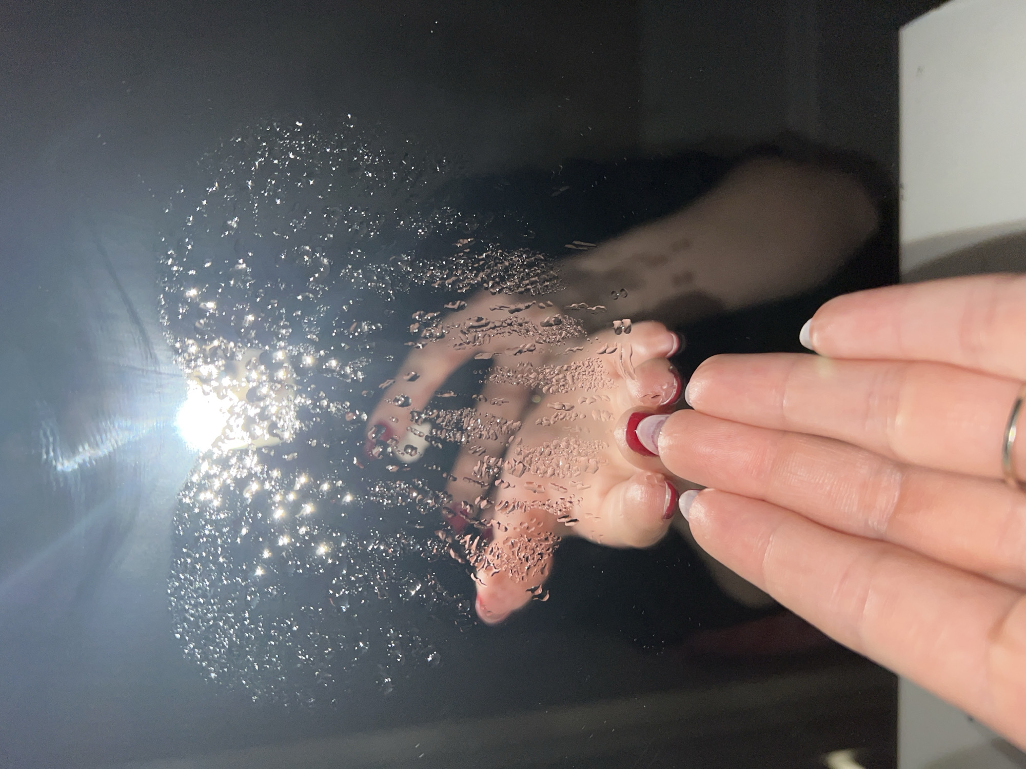 Hand touches wet reflective surface in Saint Petersburg