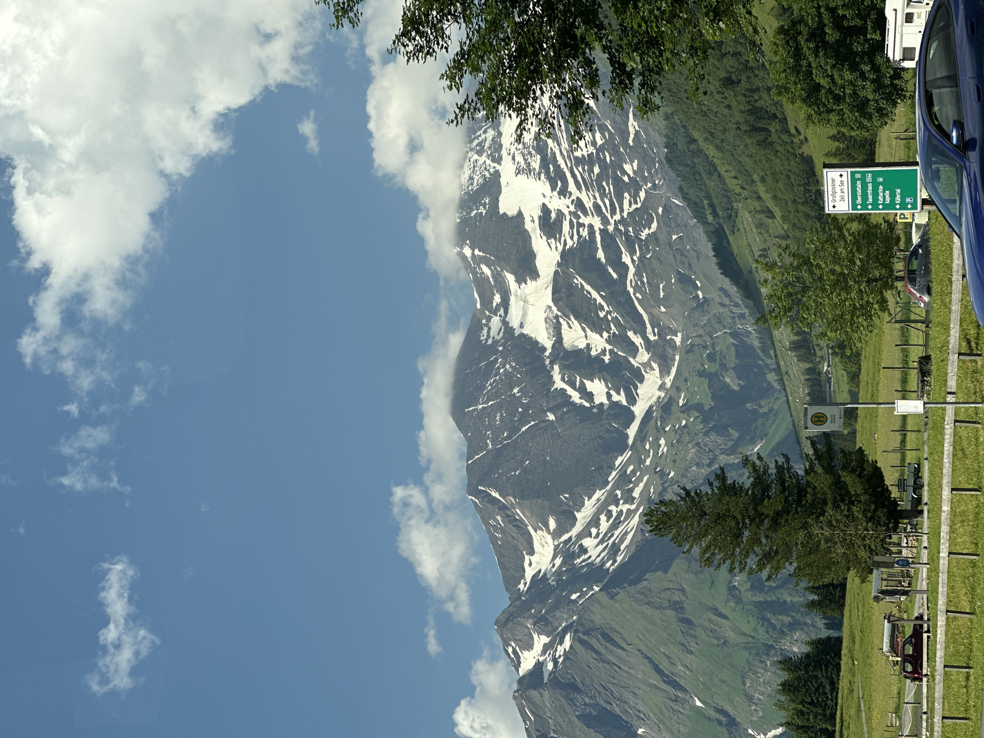 Sports cars cruise the Großglockner High Alpine Road on a clear morning