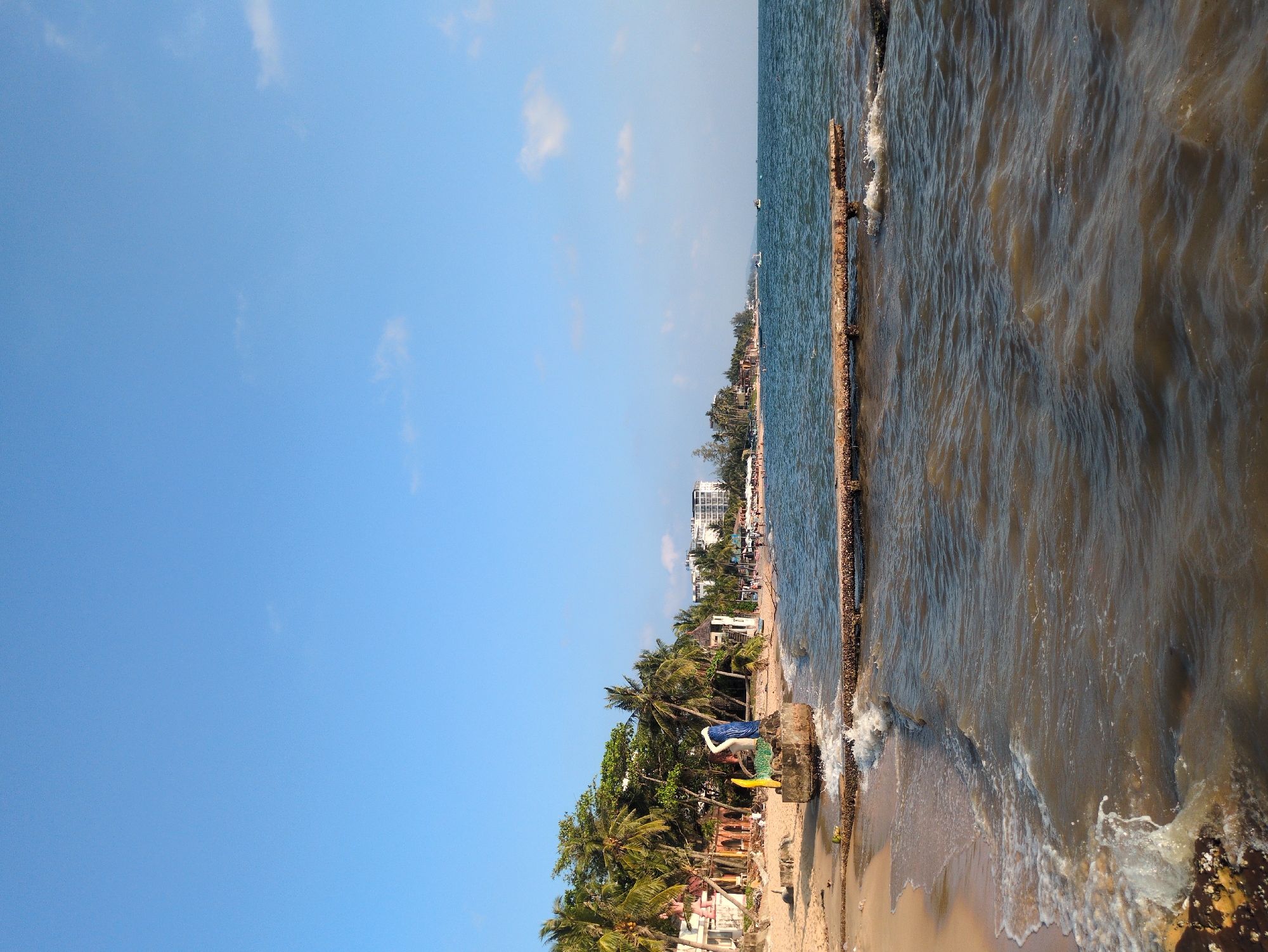 Witness documents ocean shoreline with murky brown water