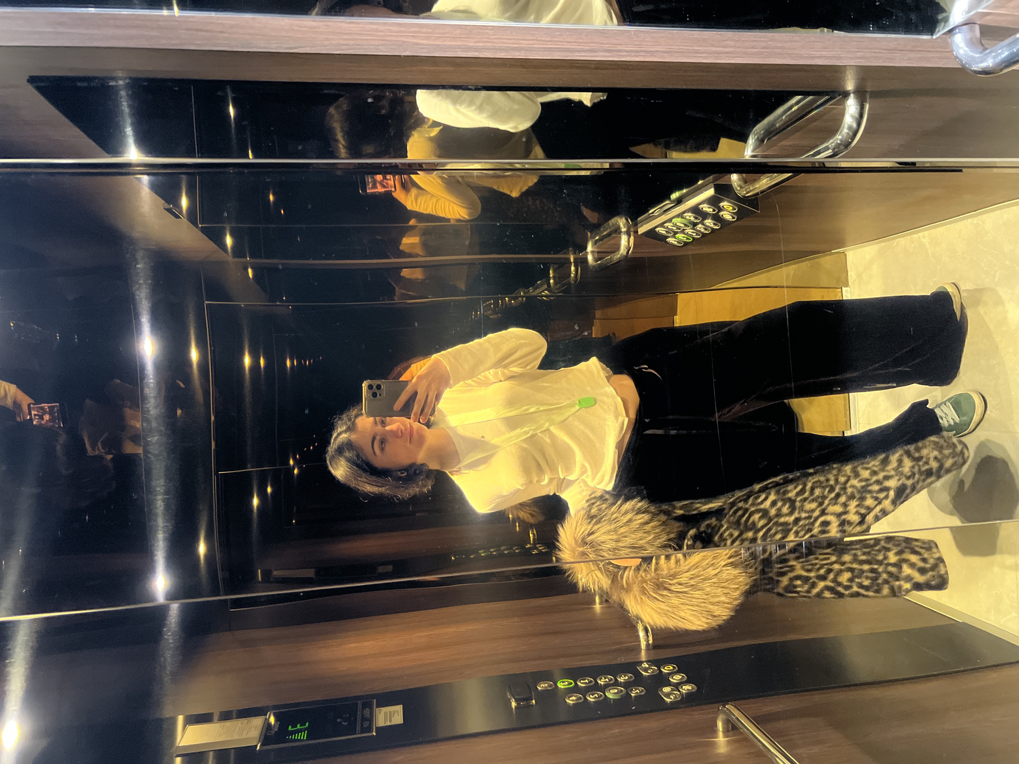 Woman takes selfie in elevator in Spa, Belgium