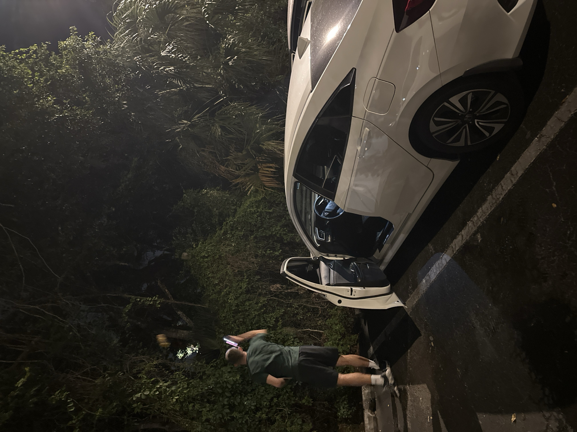 Man observed near white car at university campus nighttime