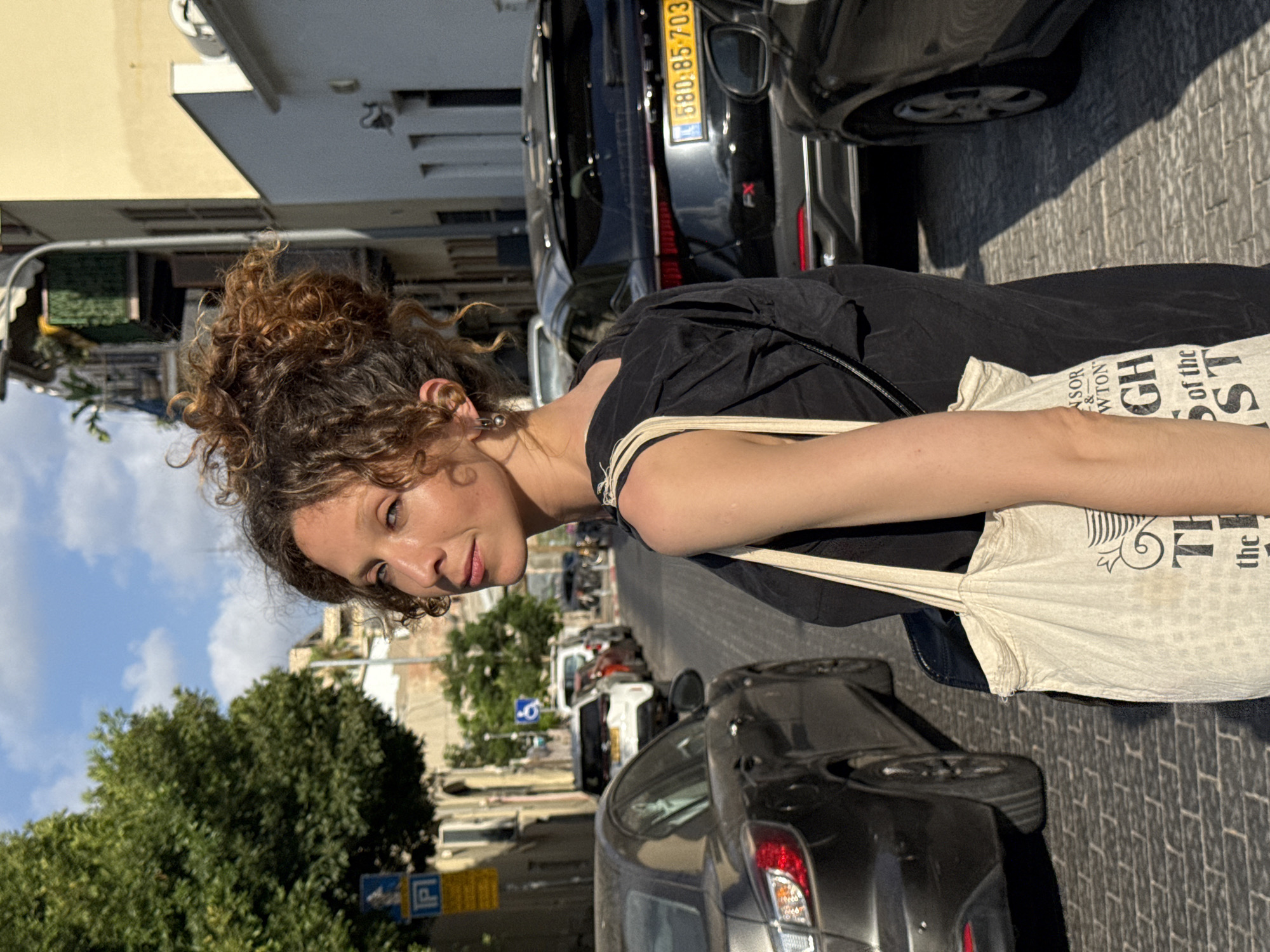 Afternoon stroll through a Tel Aviv street with a canvas tote
