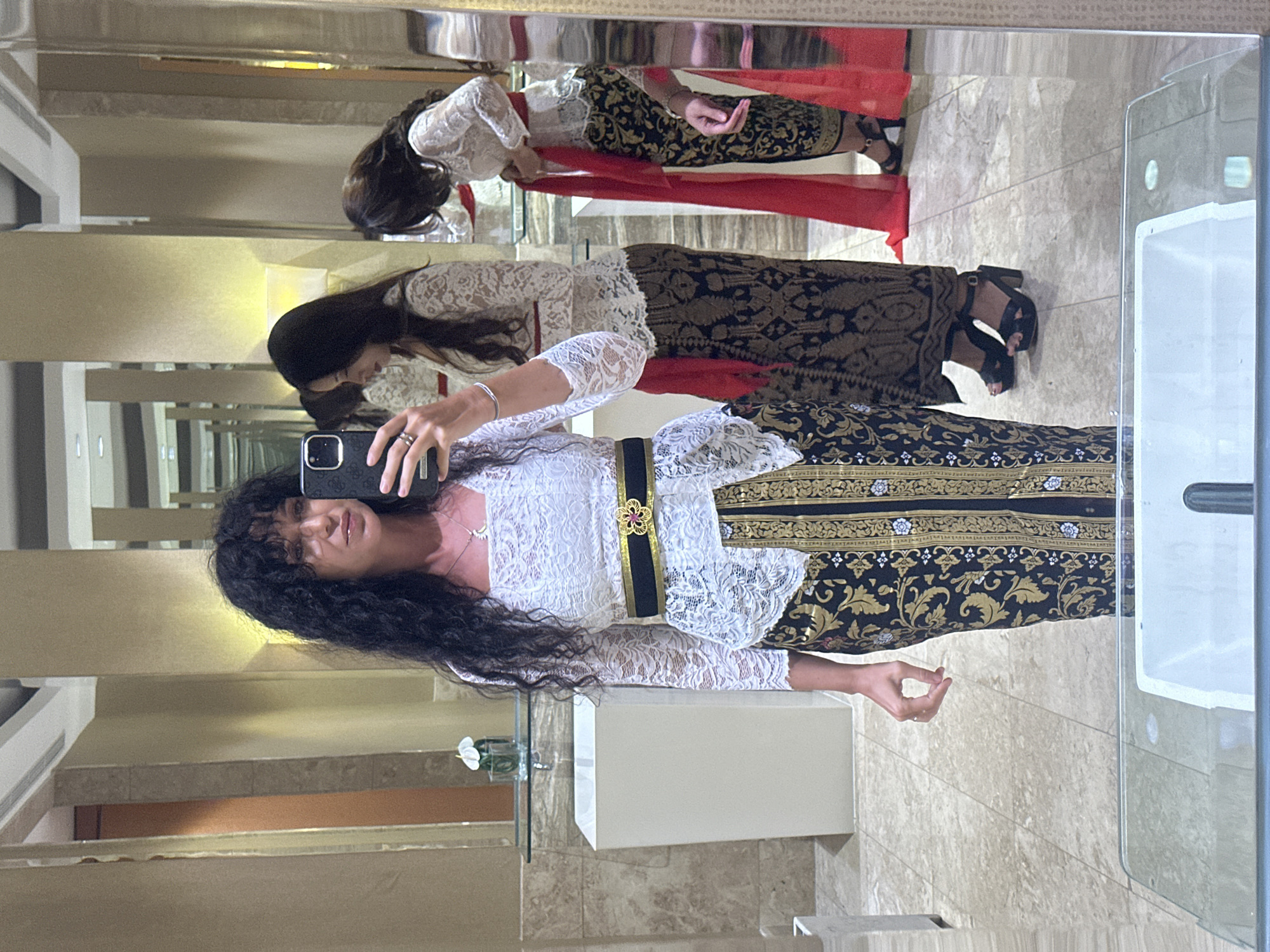 Woman in traditional kebaya takes selfies in Kuta Selatan
