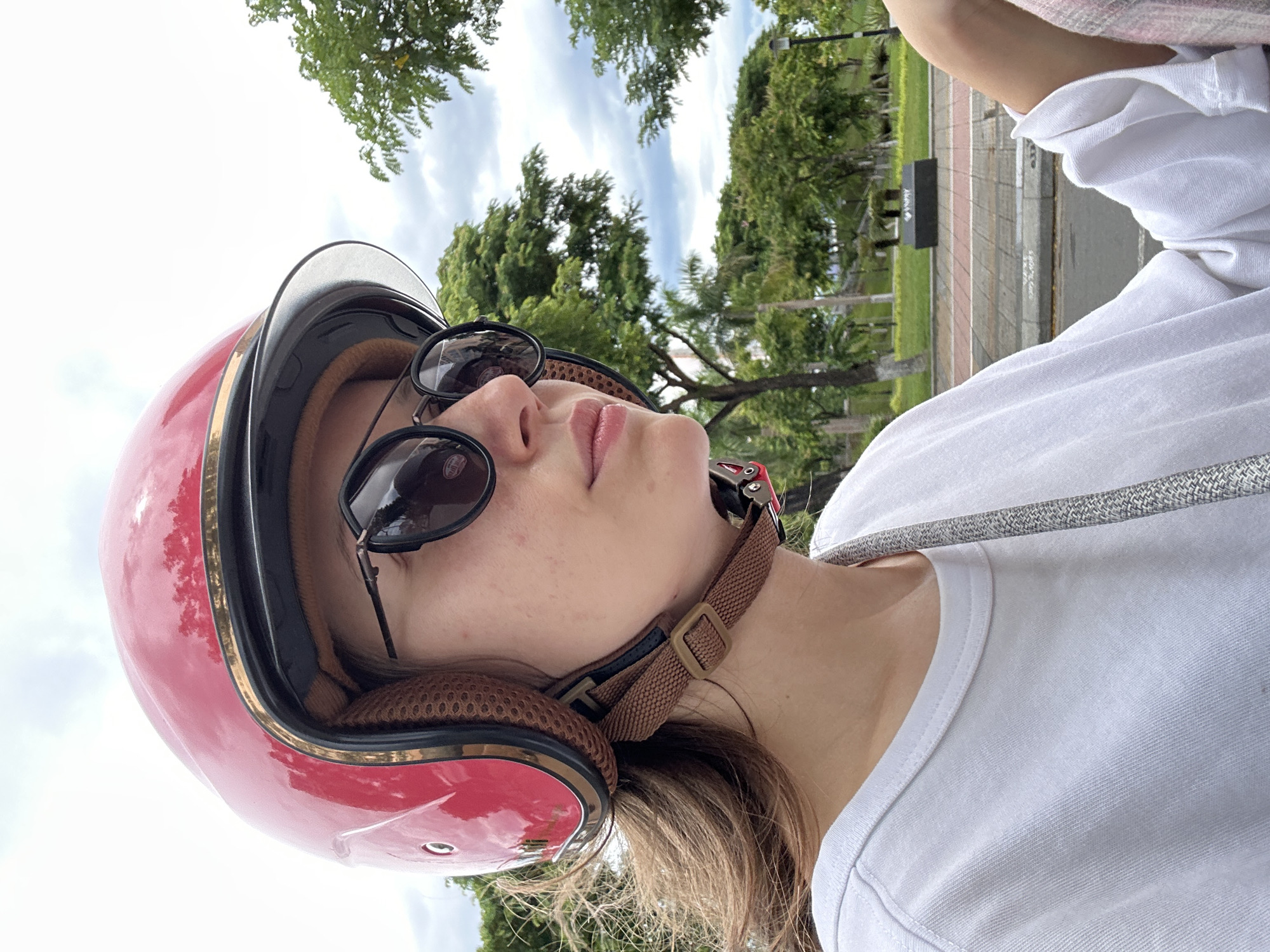 Scooter rider on a cloudy Đà Nẵng street, July morning
