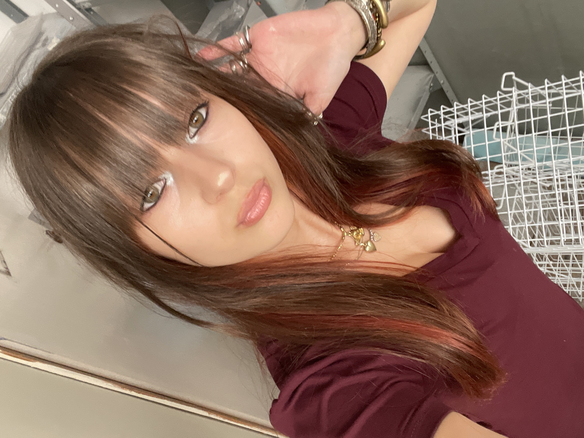 Woman takes selfies in maroon shirt in Raanana
