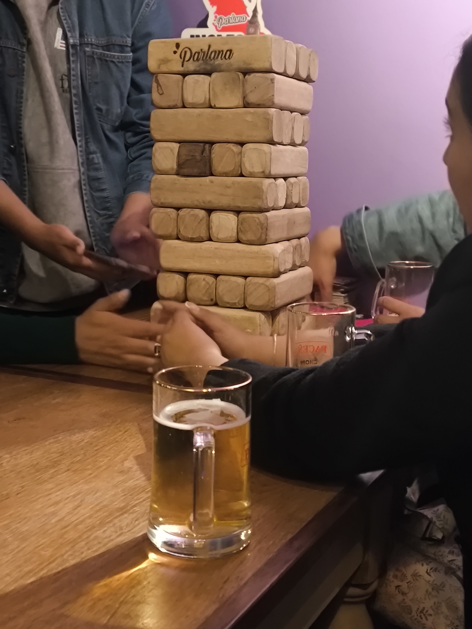 Late-night social gathering features Jenga, flags, beer in La Paz