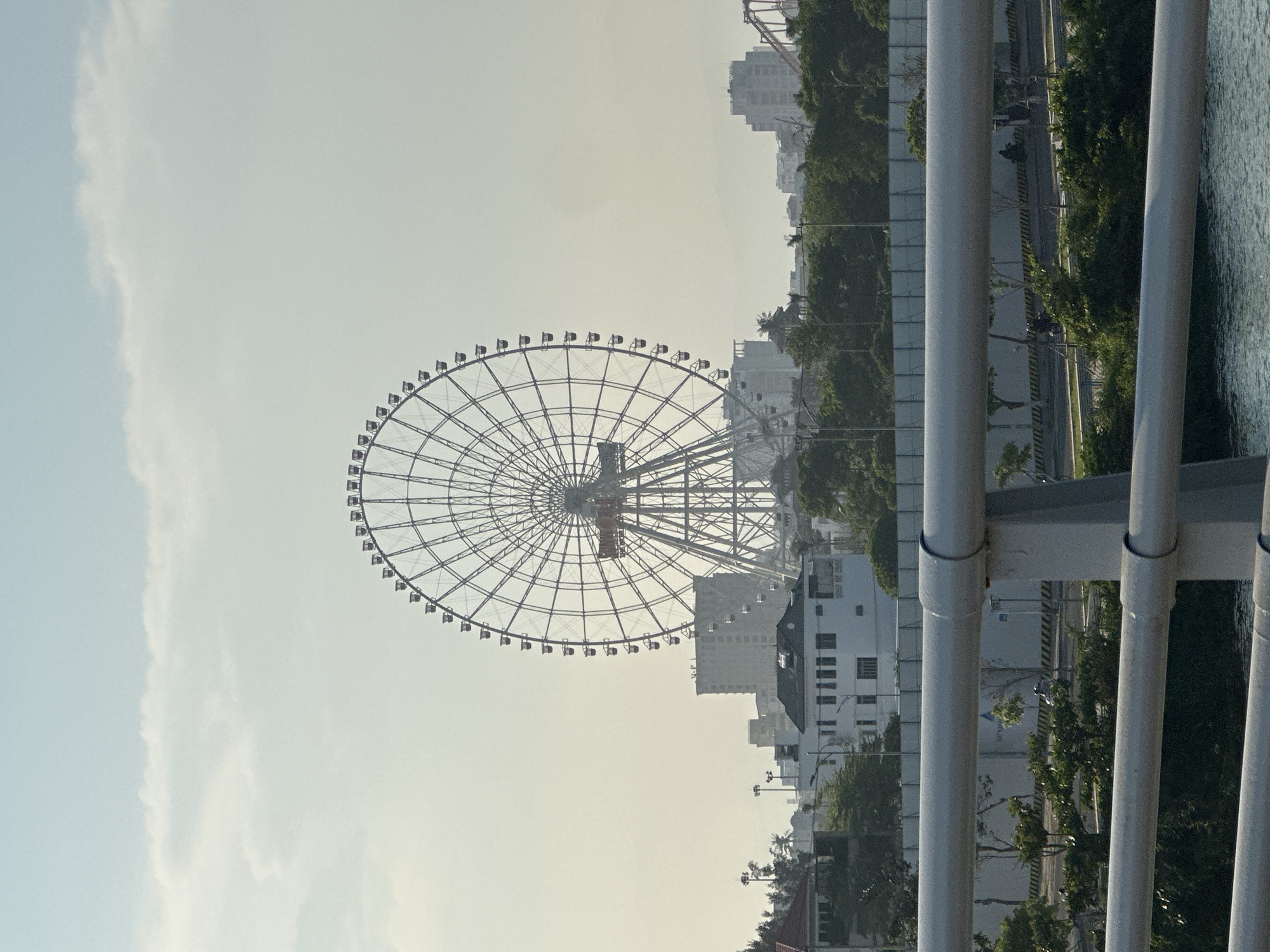 Tourist captures Sun Wheel Ferris wheel view from bridge