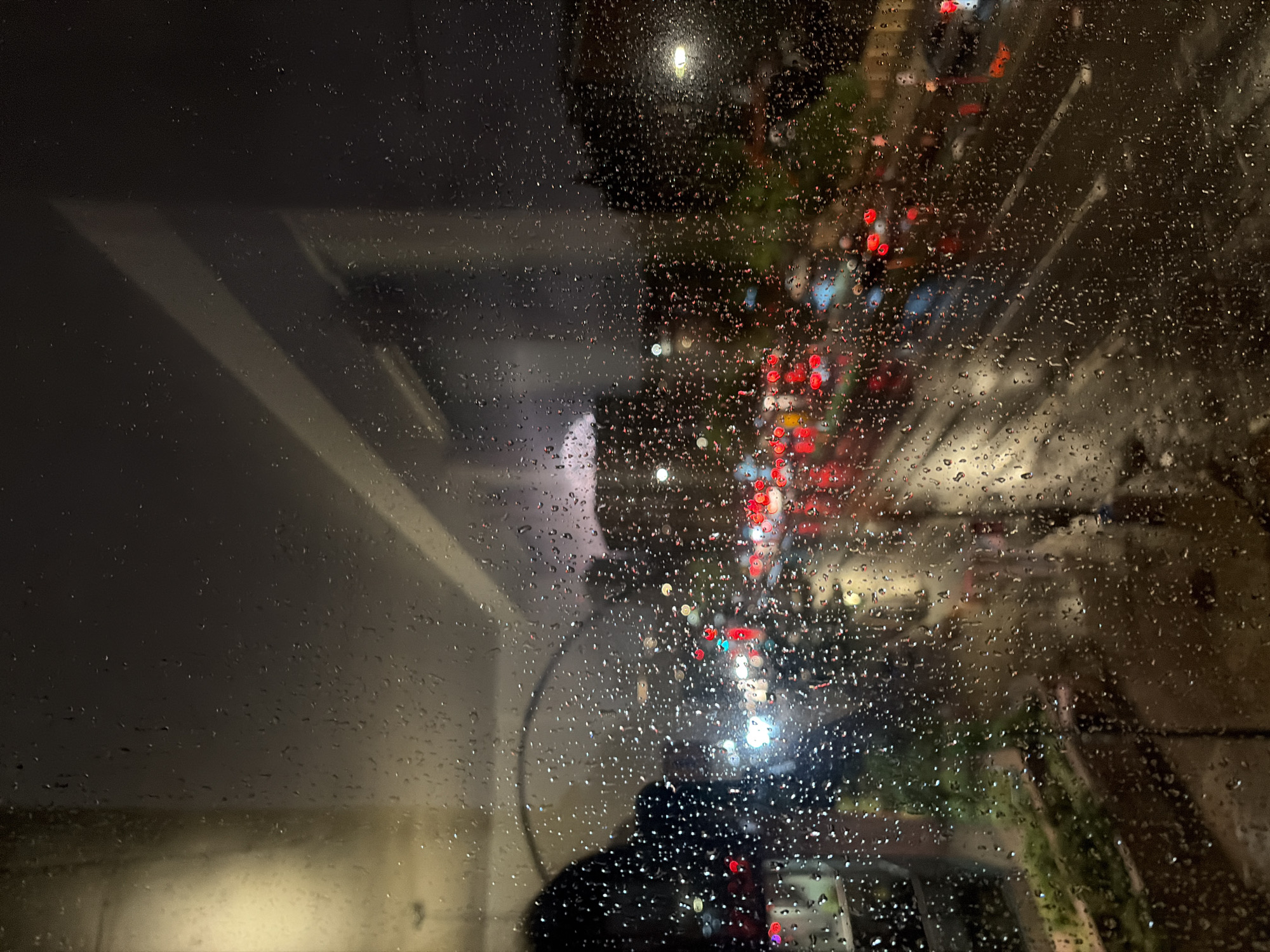 Montreal city street at night, seen through a rain-covered window