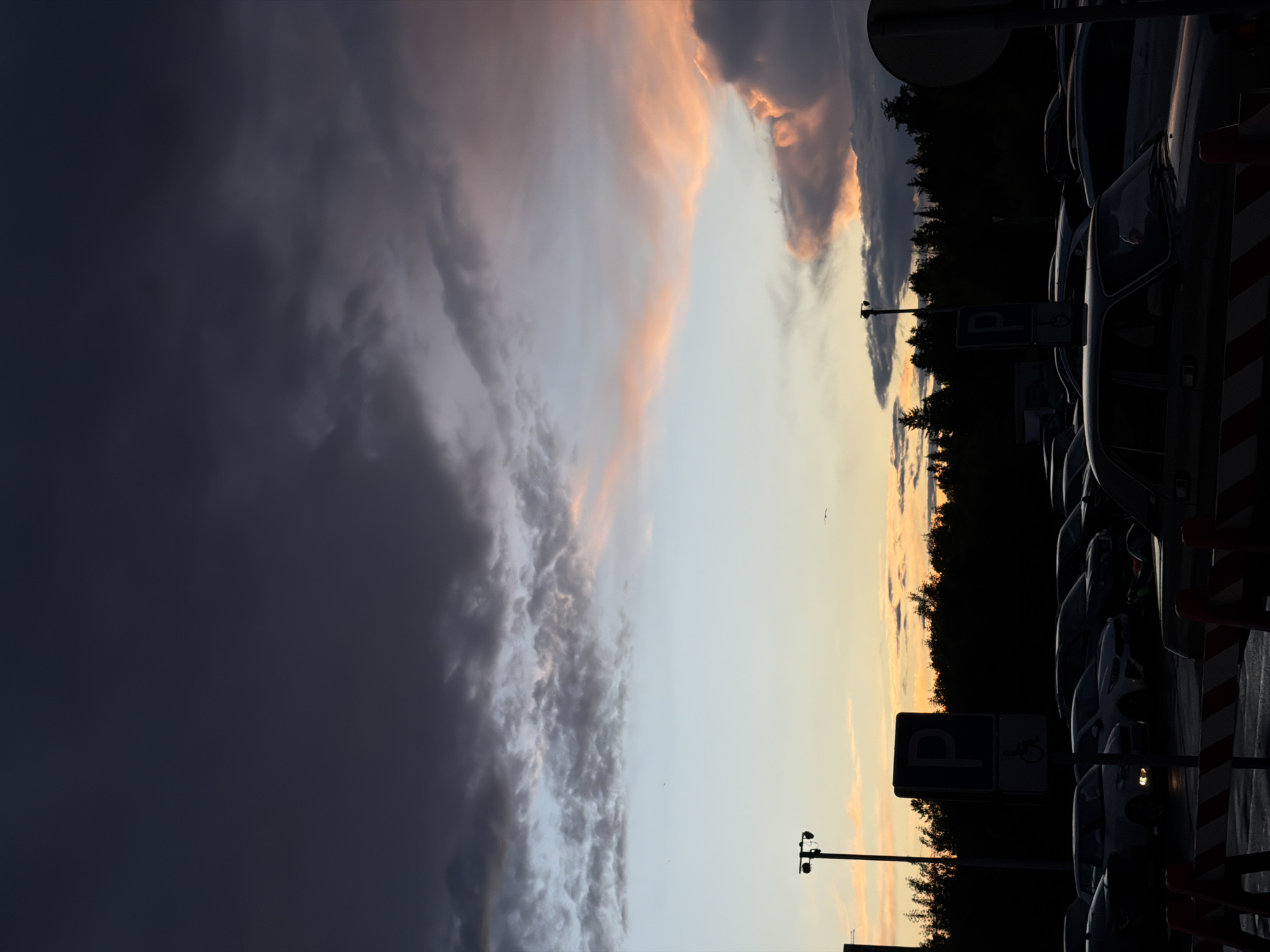Evening scenes documented across Izhevsk parking areas, dramatic clouds