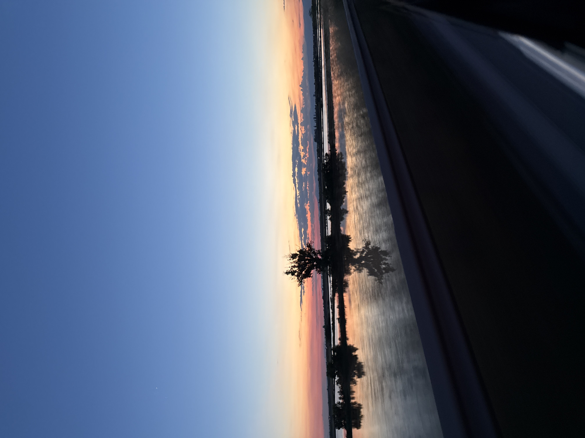 Driver Documents Sunset Journey Through Rural Landscape