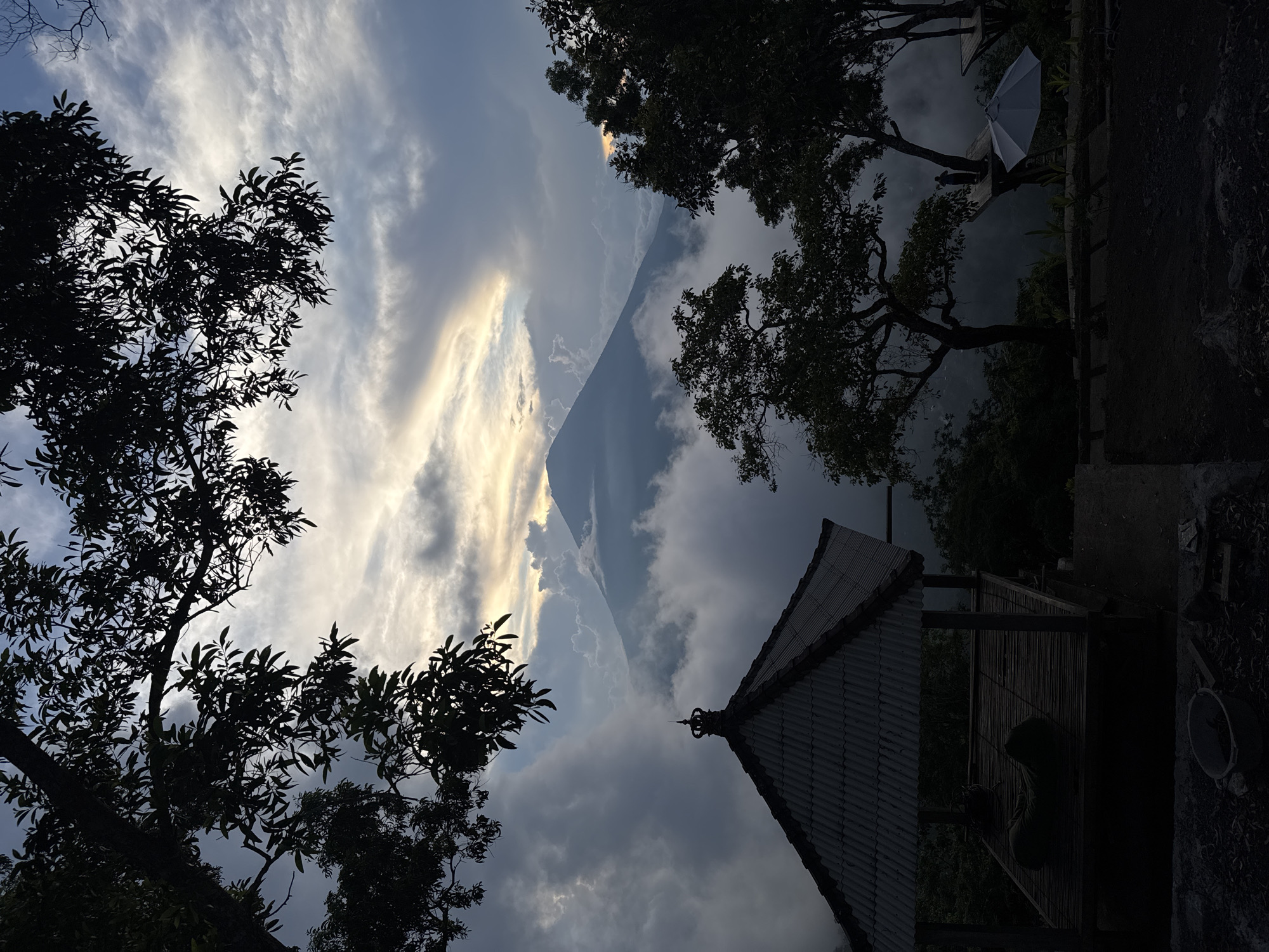 Sunlight breaks through clouds over Kertha Mandala building
