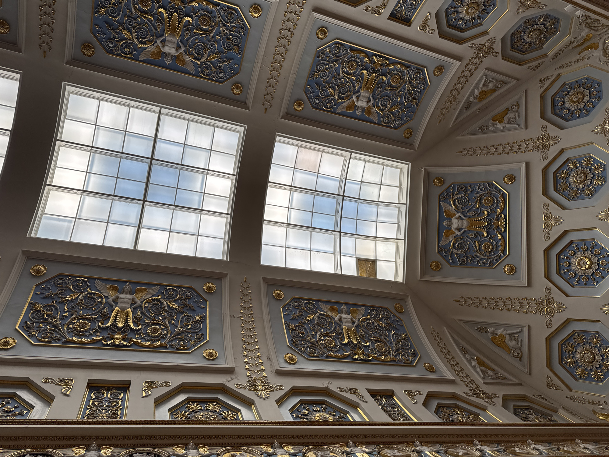Gilded ceilings and ornate bas-relief in a grand historic interior