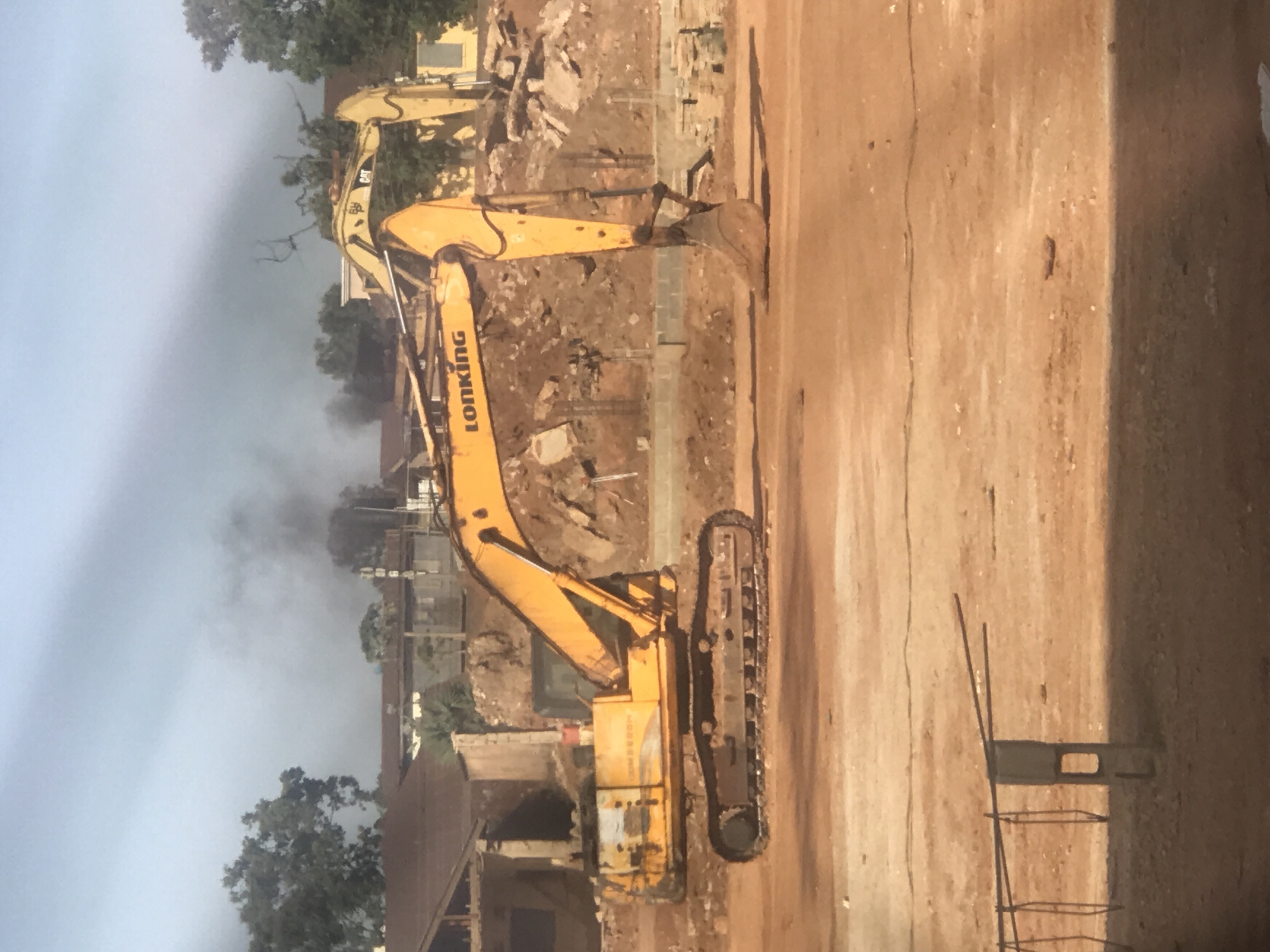 Stadium construction underway in Jos, Nigeria with heavy machinery