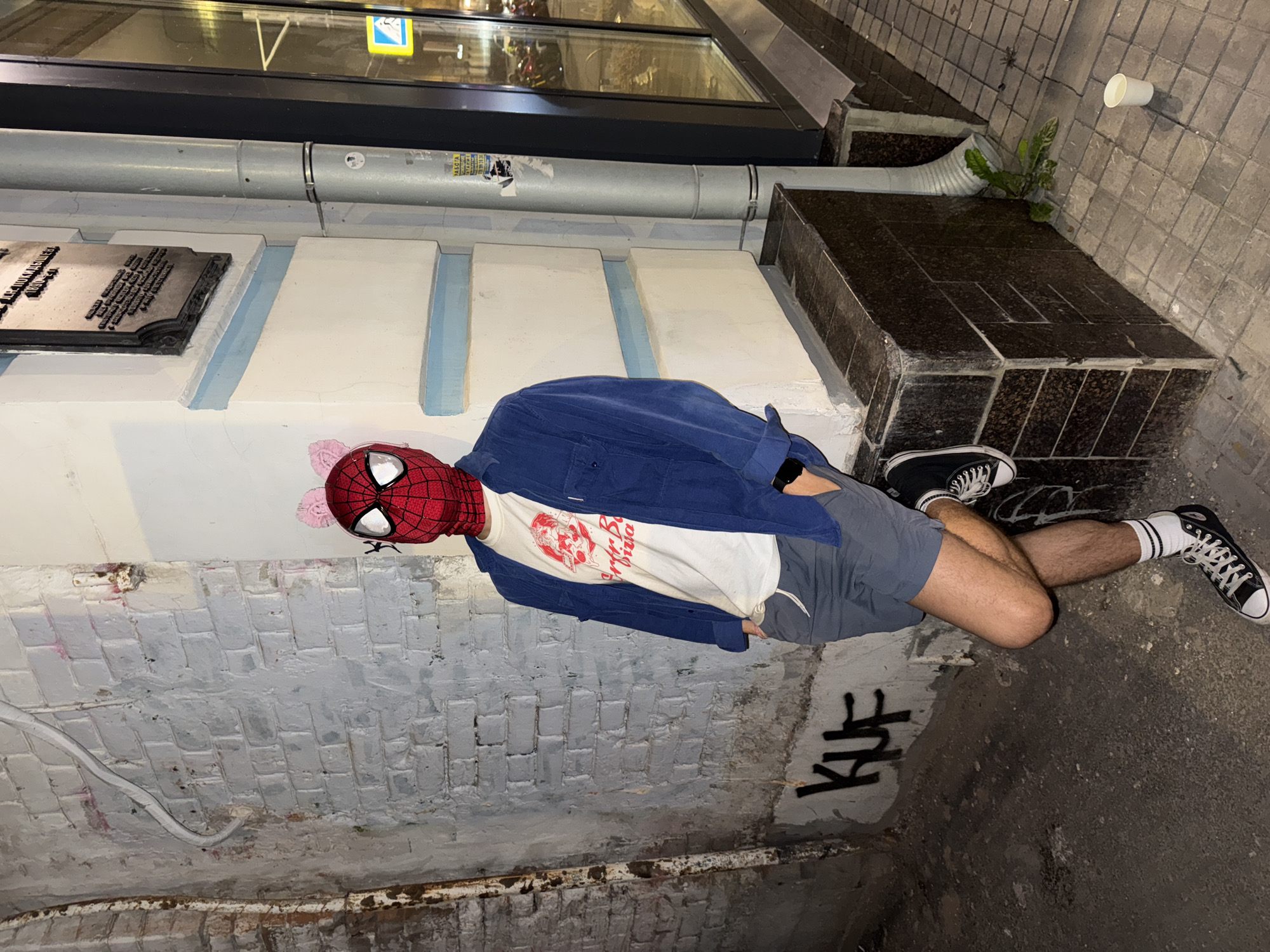 Spider-Man mask and cat merch on a quirky night out