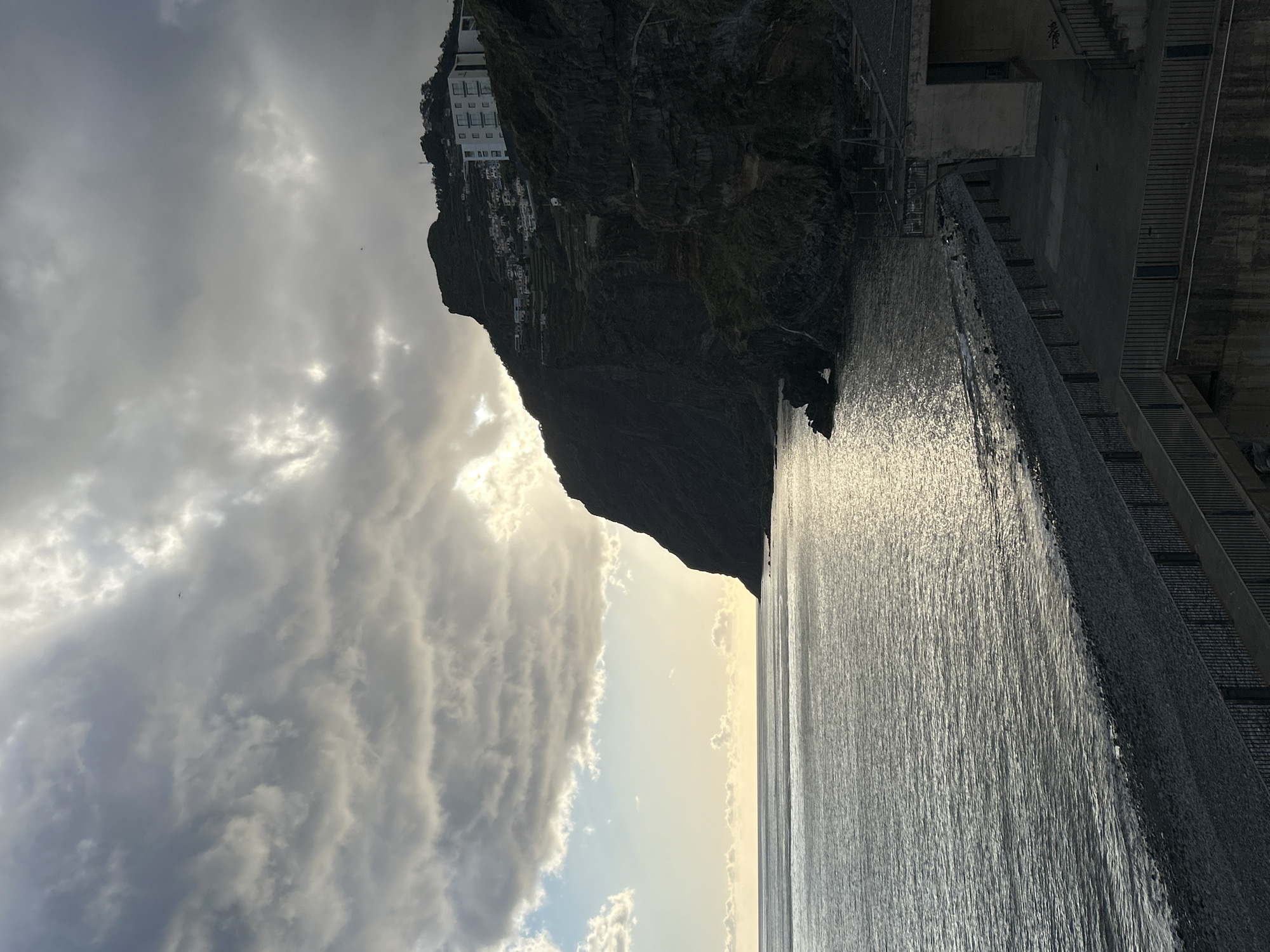 Tourist documents evening scenes in Câmara de Lobos harbor