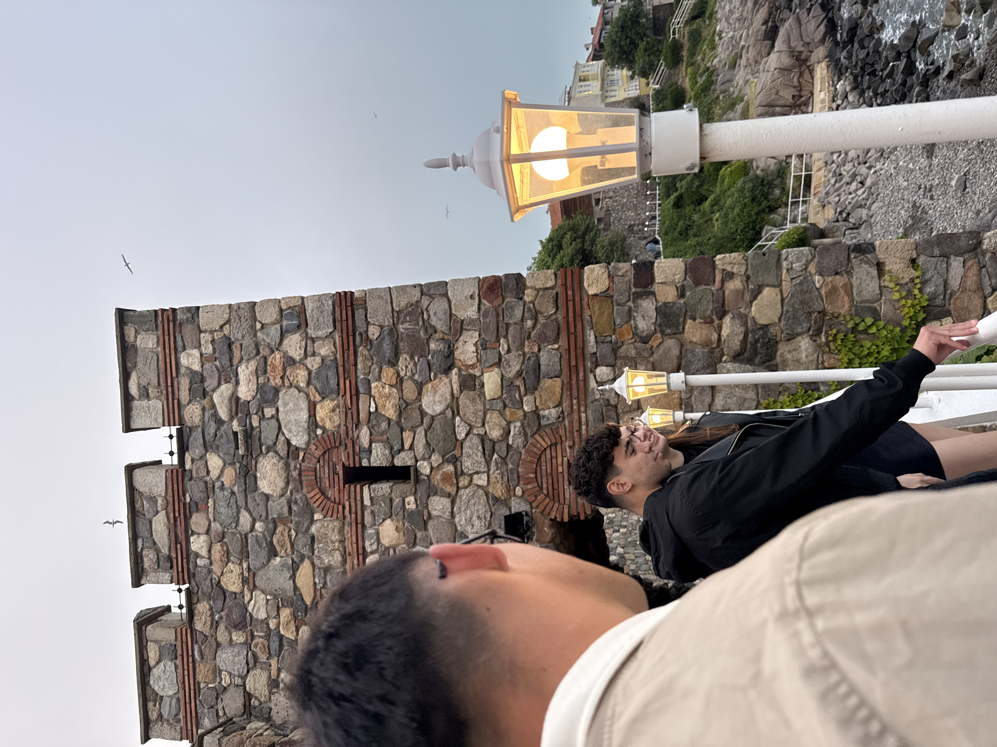 Tourists explore historic Sozopol coastline under overcast skies