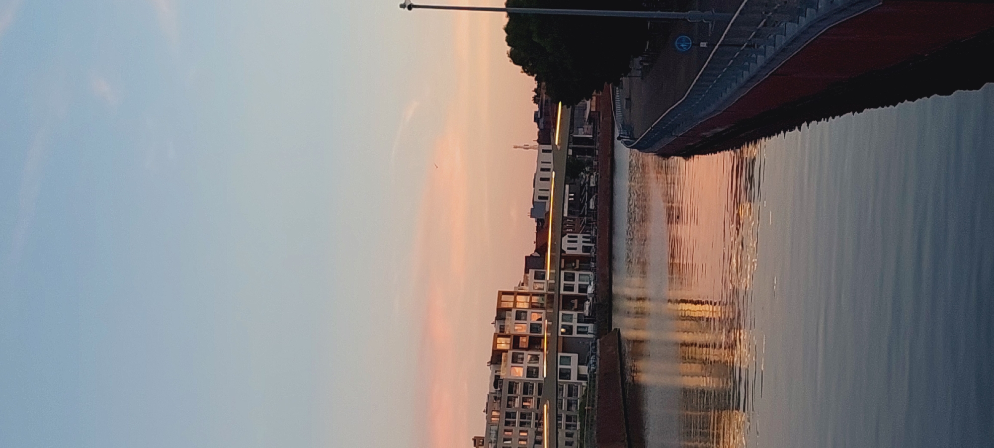 Spiders and a sunset along an urban waterfront