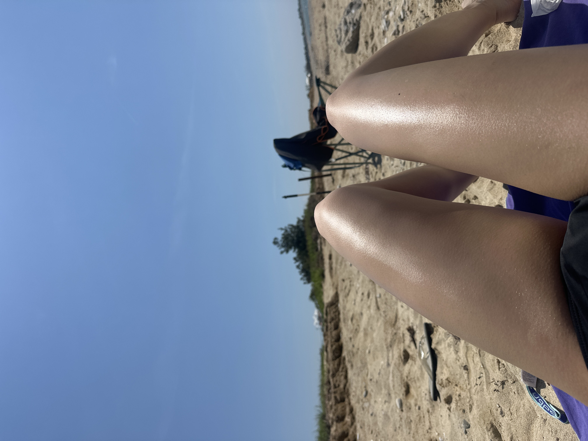 Beachgoer documents sunny relaxation session at Ofrynio Beach, Greece