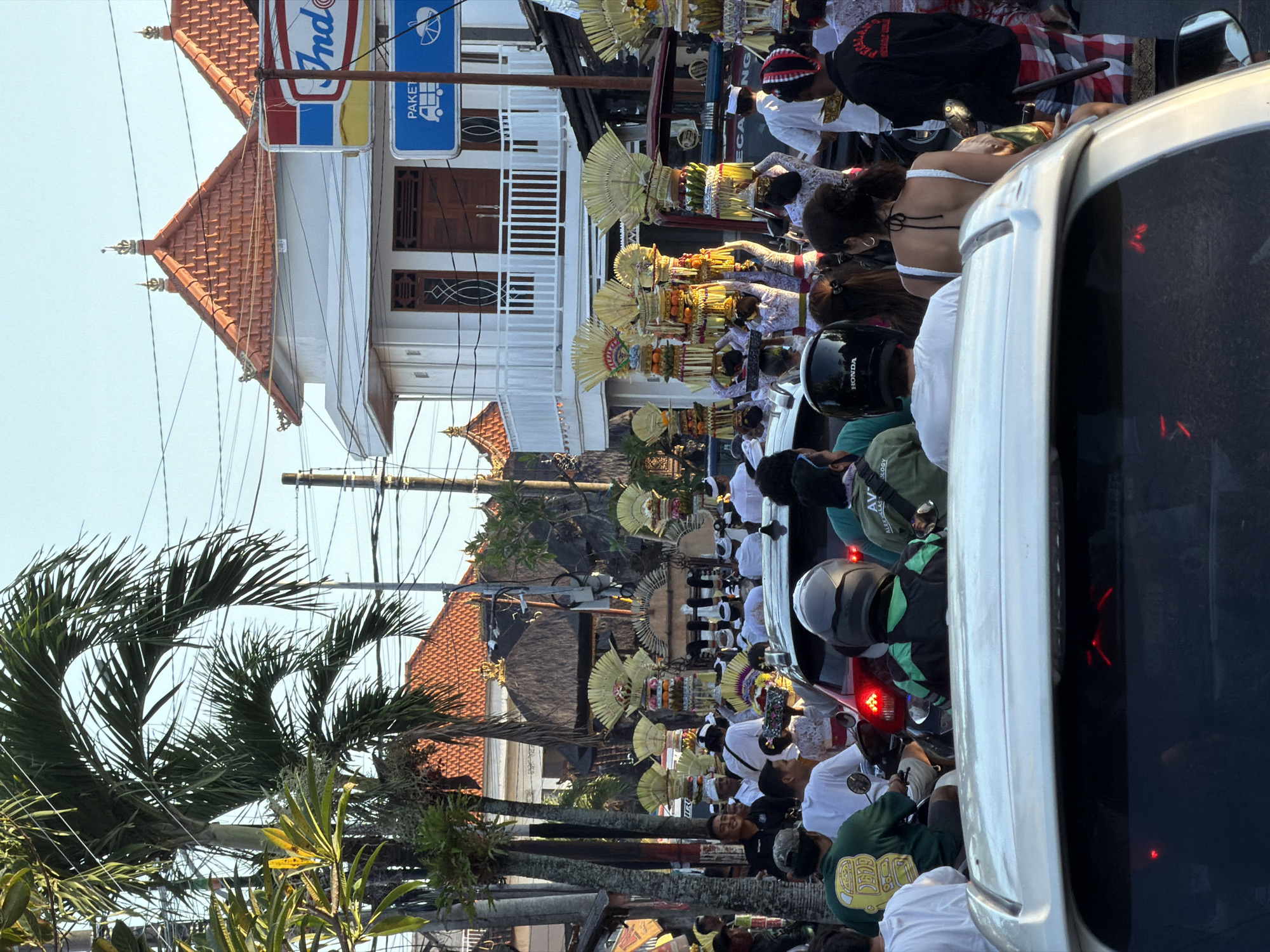 Traditional Balinese Hindu procession carries ceremonial offerings in Mengwi