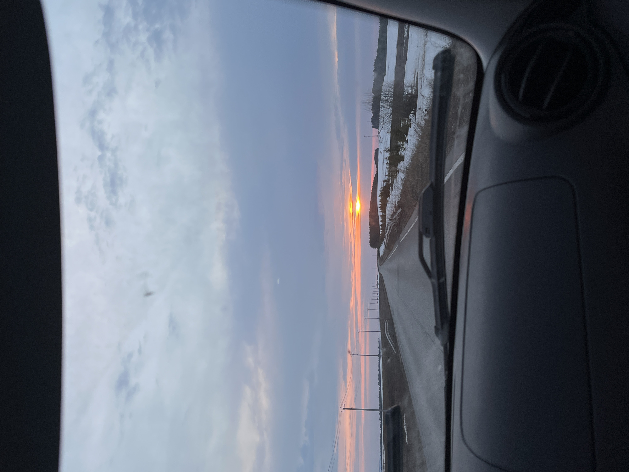 Sunset view captured from vehicle on snowy Russian road