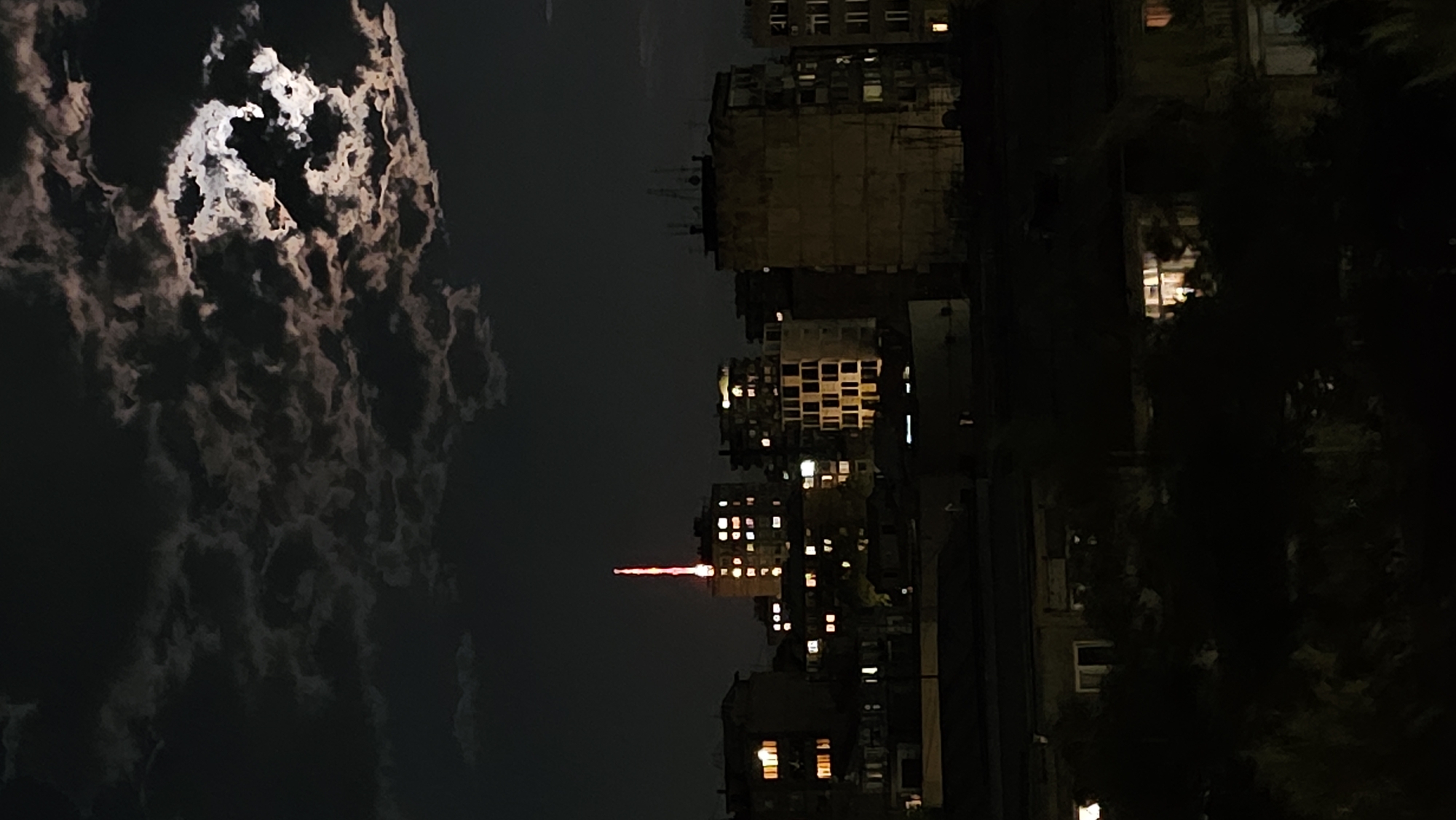 Full moon rises over Yerevan on a cloudy night