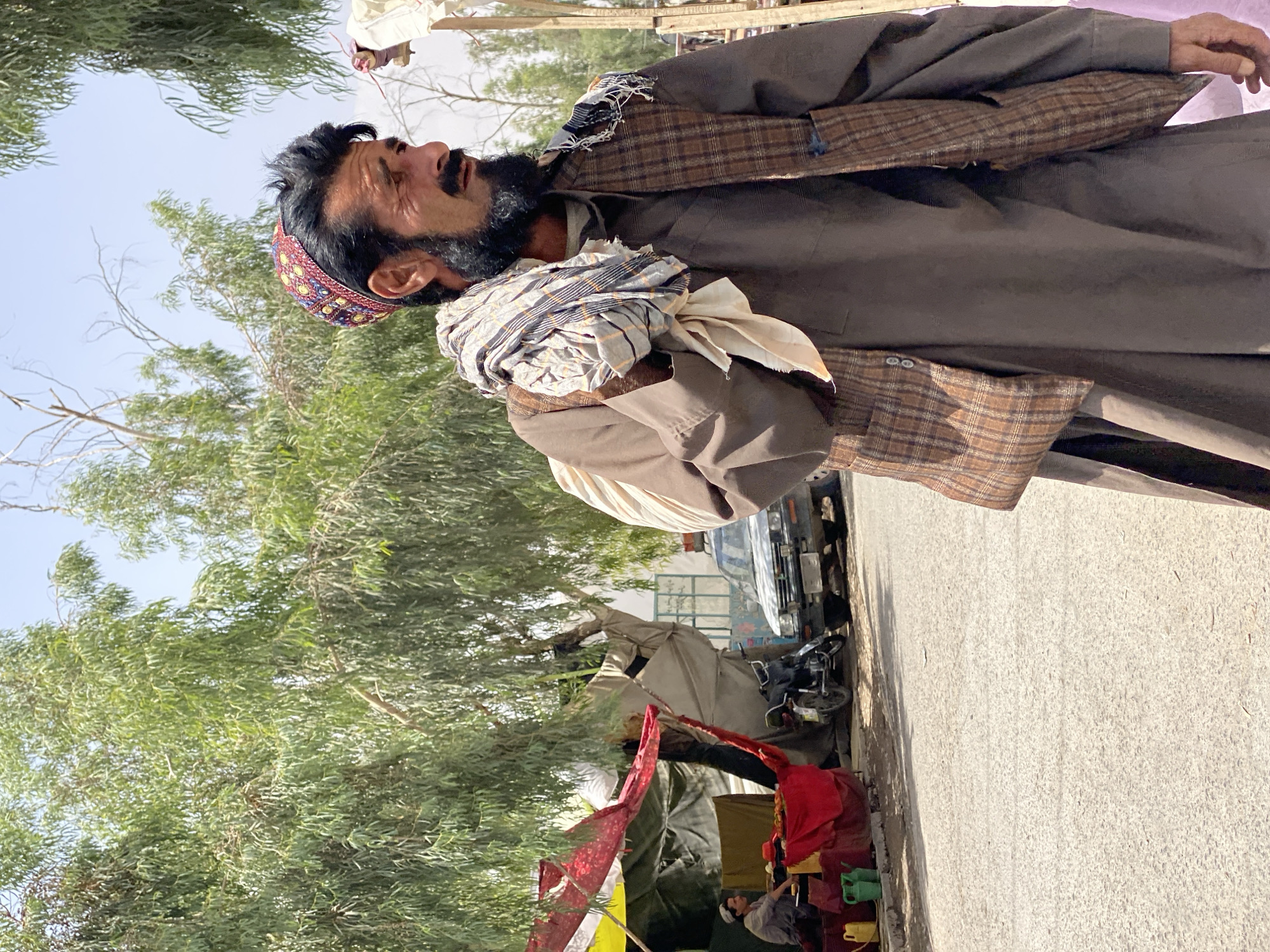 Street life in Kandahar: market stalls and a wheelbarrow