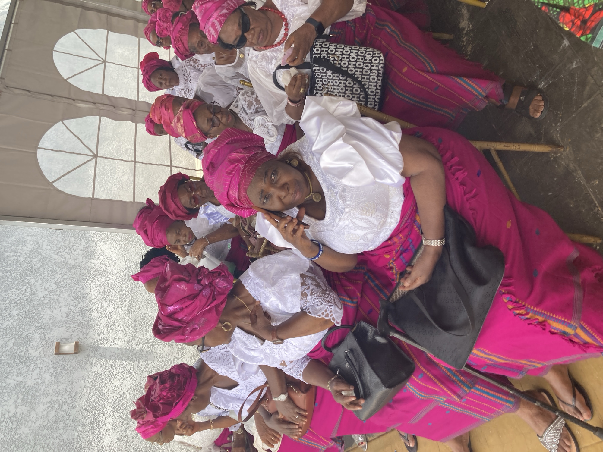 Women in matching pink attire gather for celebration in Nigeria