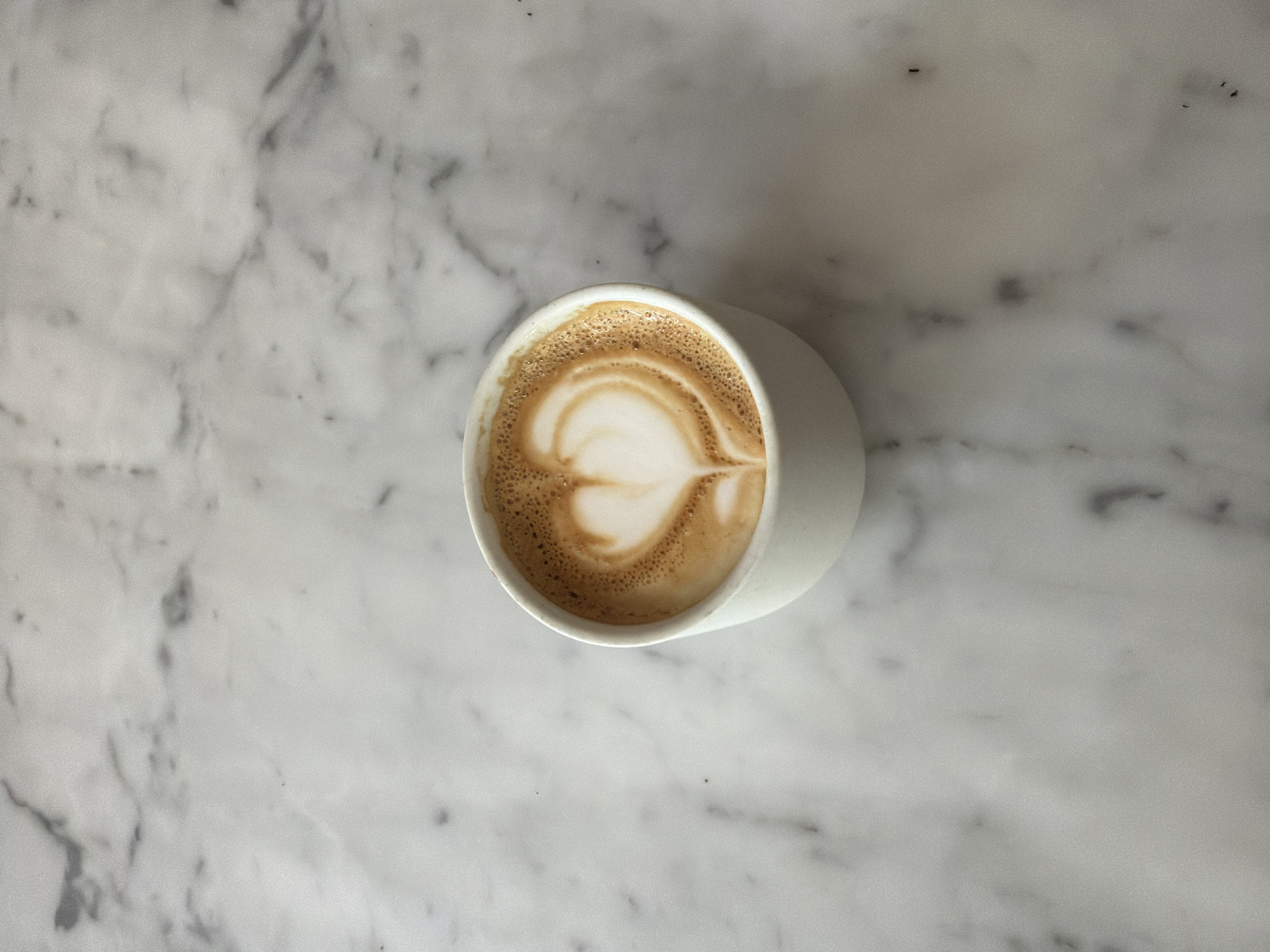 Heart-shaped latte art photographed in Los Angeles coffee cup