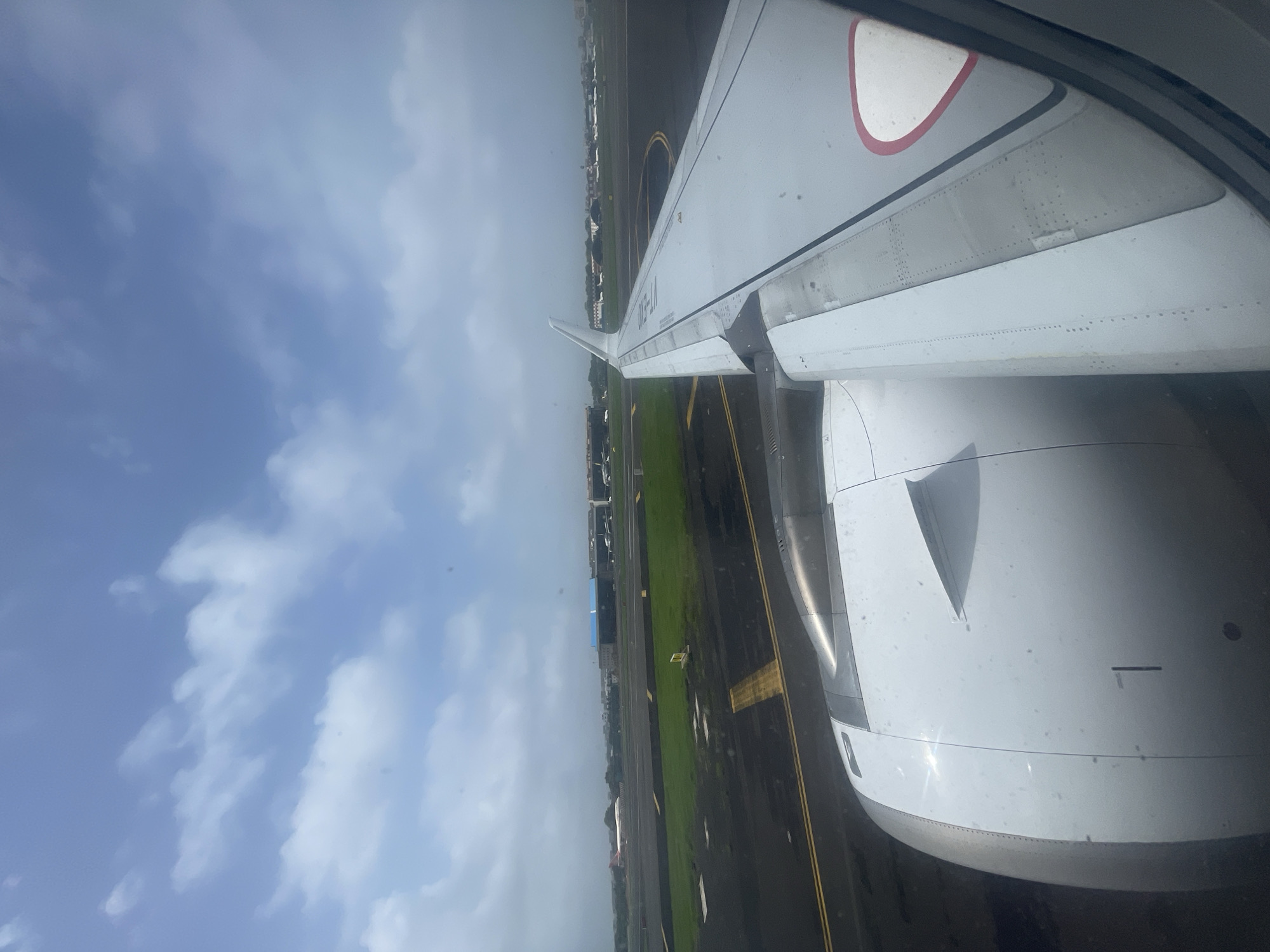 On the ground at Mumbai airport, wet runway, waiting to move