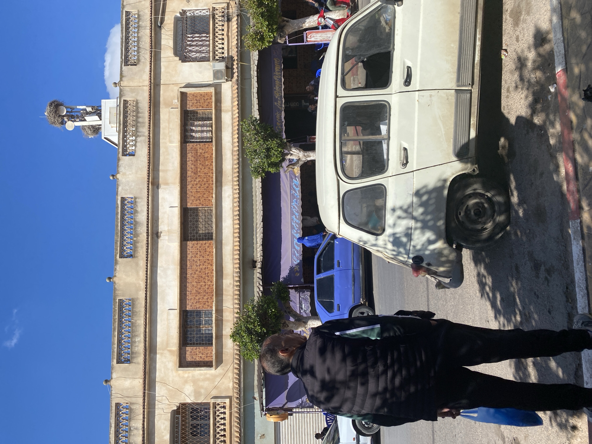 Street scene with van and car observed in Ben Freha, Algeria