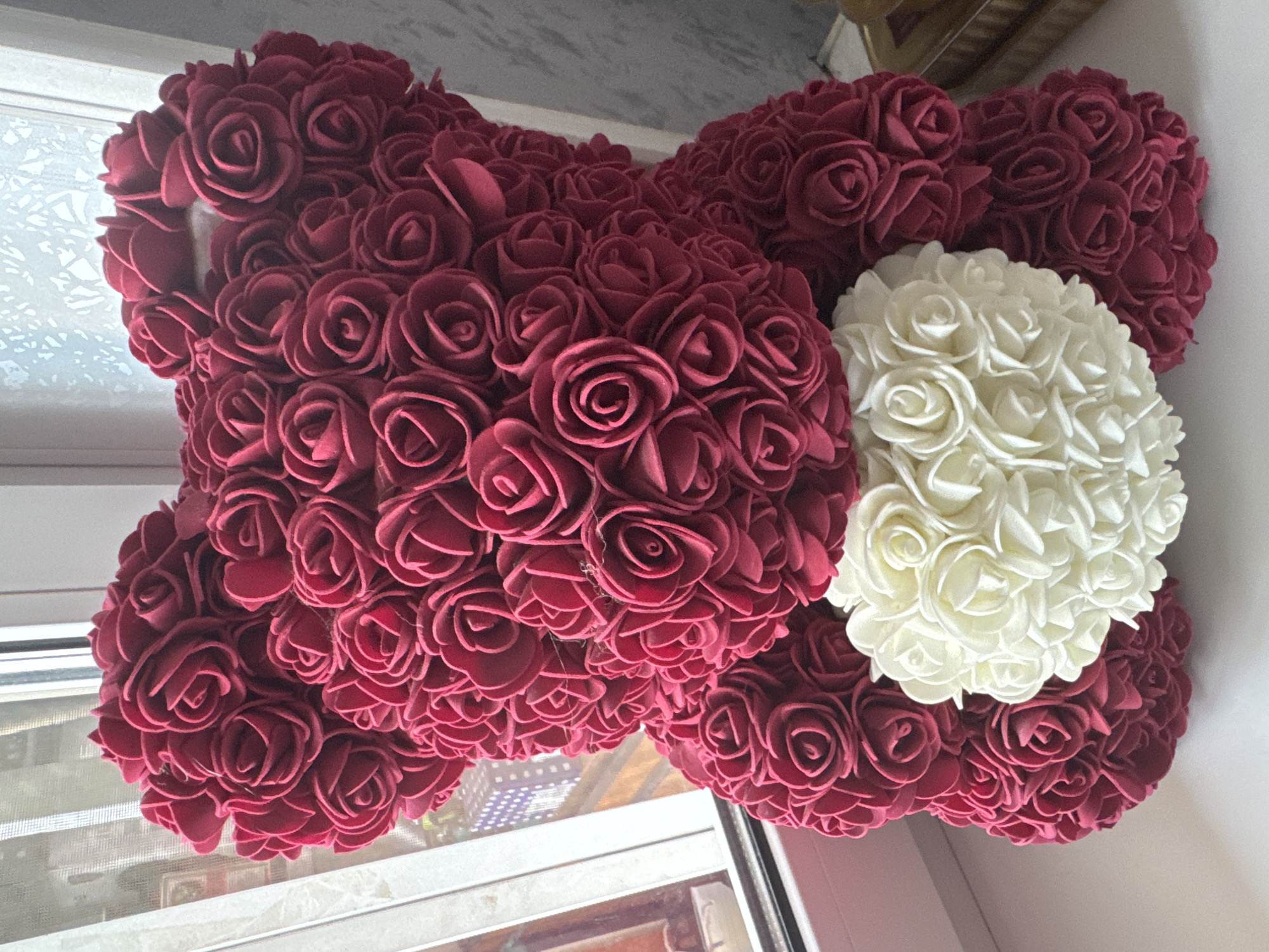 Artificial rose arrangements and a glimpse of natural foliage