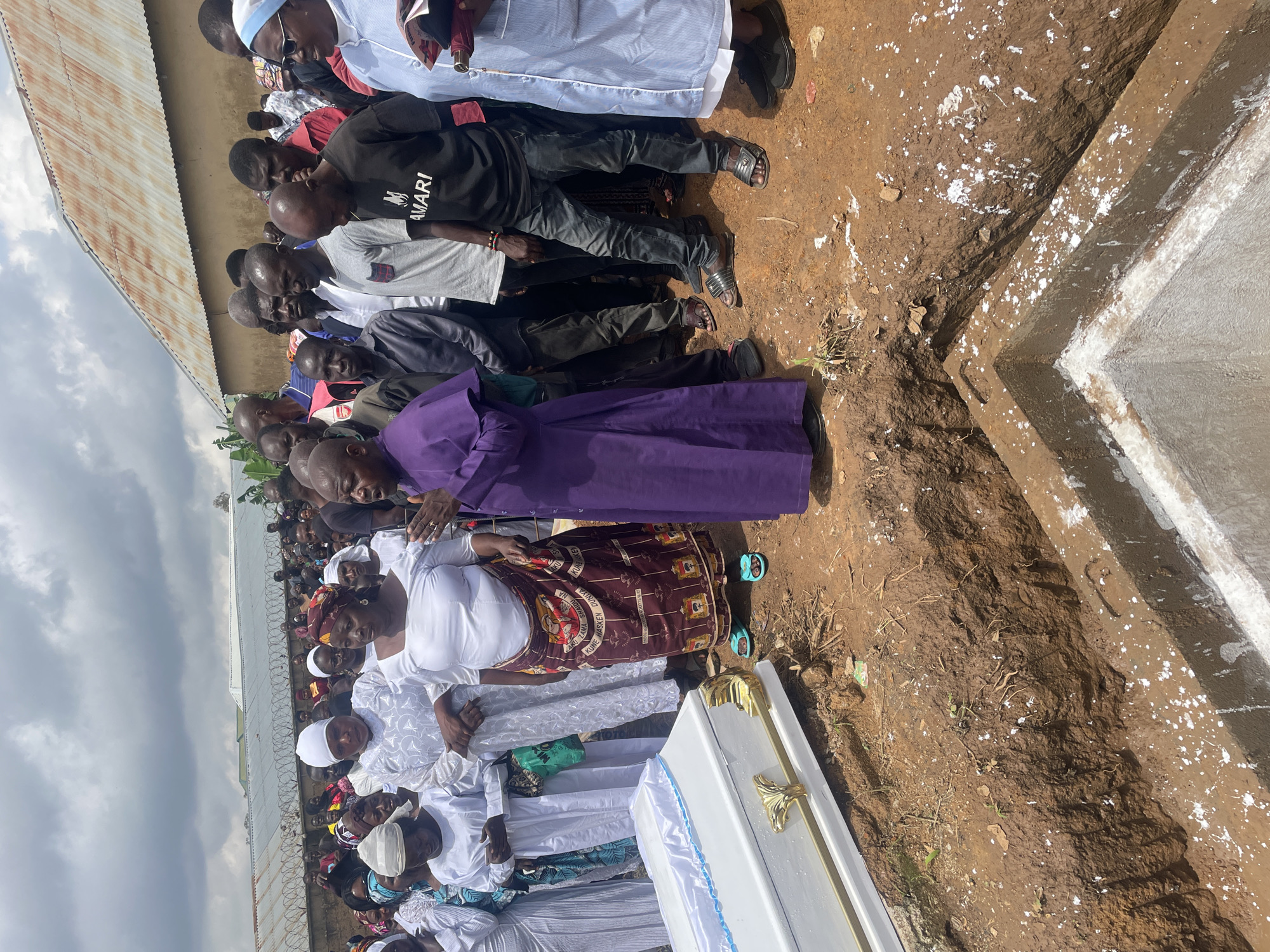 Burial ceremony underway at a graveside in Gura Top, Nigeria