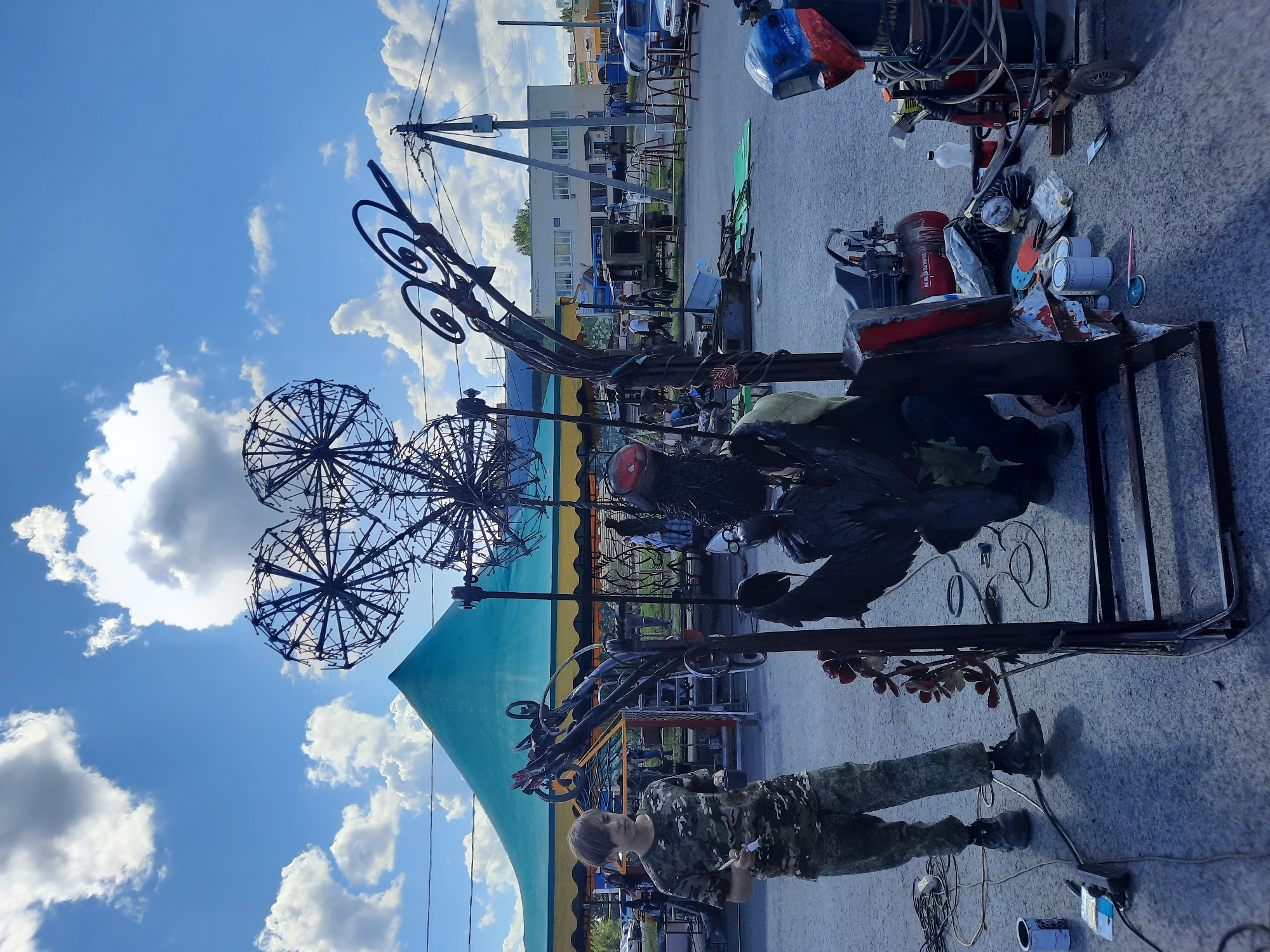 Metal sculptors at work during an outdoor art event in Зеленогорский