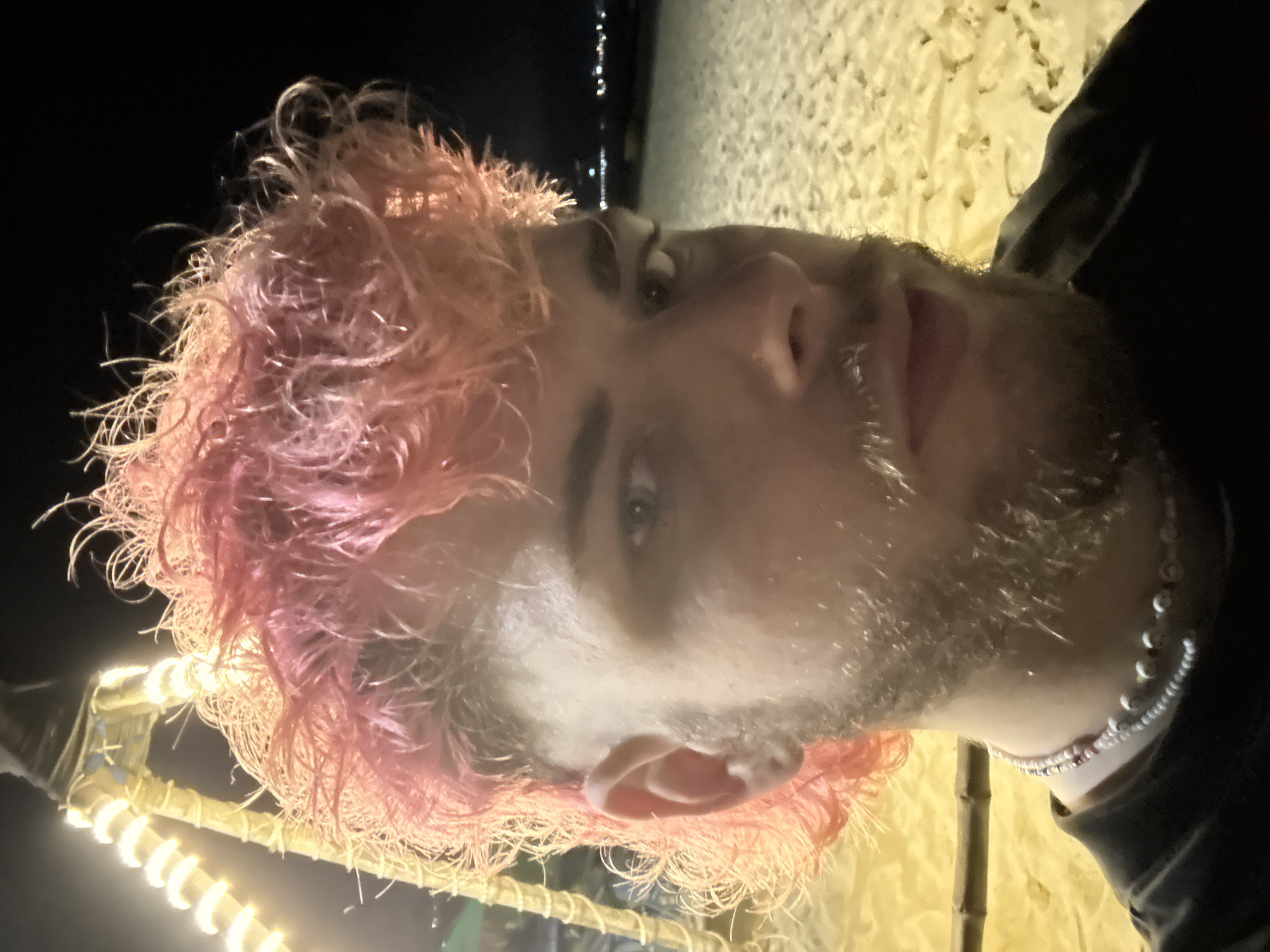 Pink-haired visitor enjoys illuminated beachside setup in Đà Nẵng