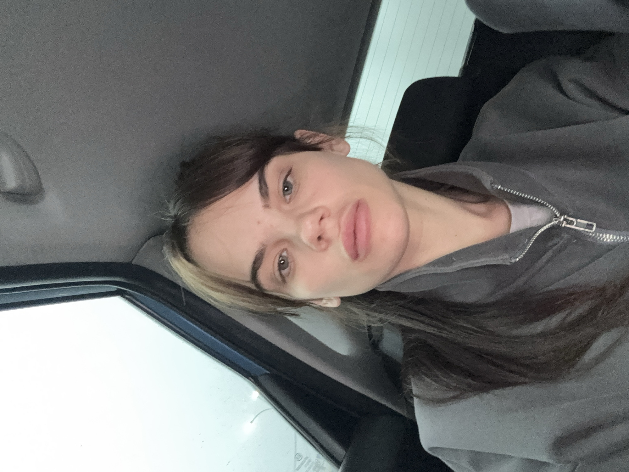 Woman takes car selfie in overcast Камышеваха morning
