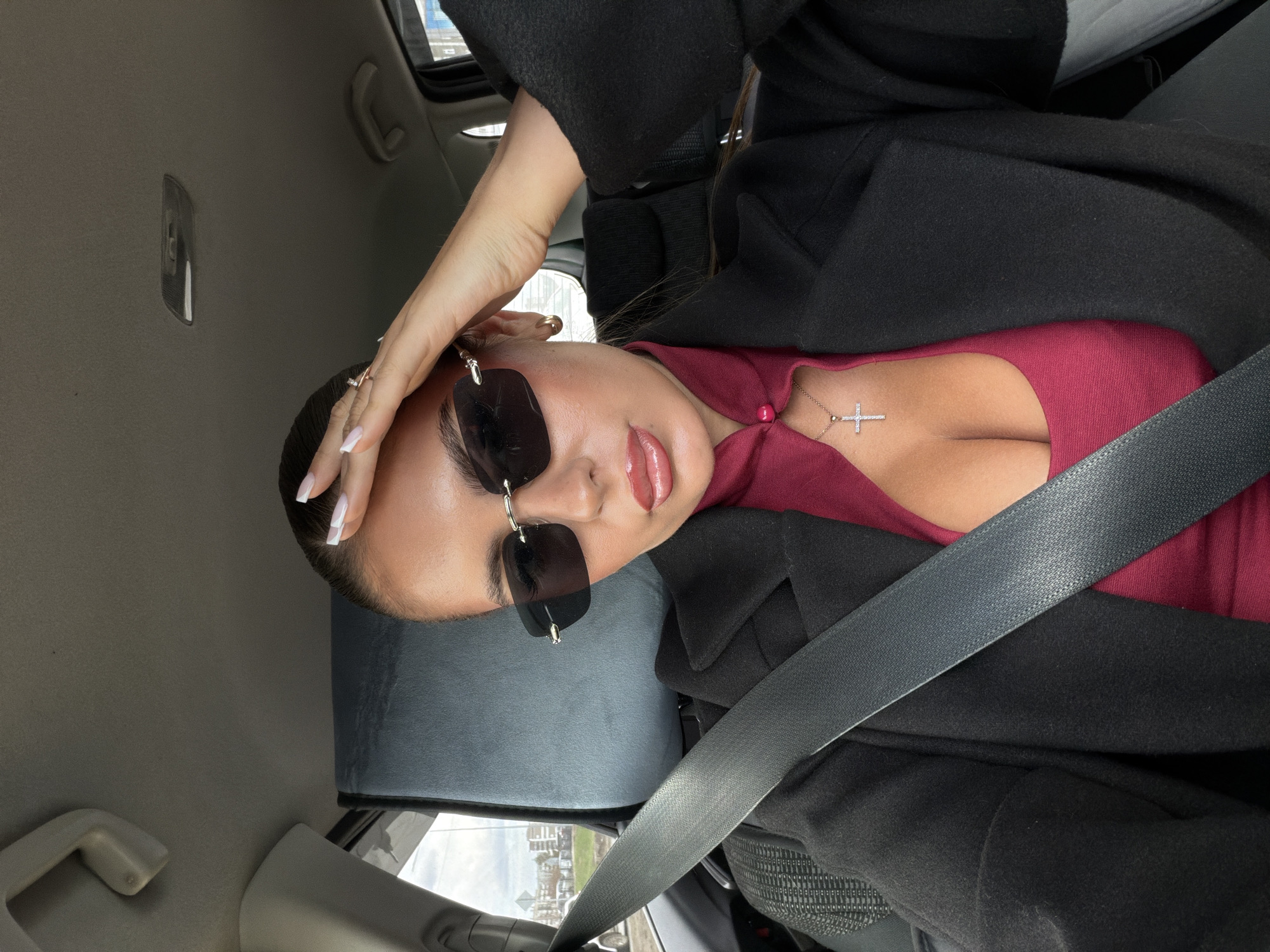 Woman poses for photo inside car in Krasnoyarsk