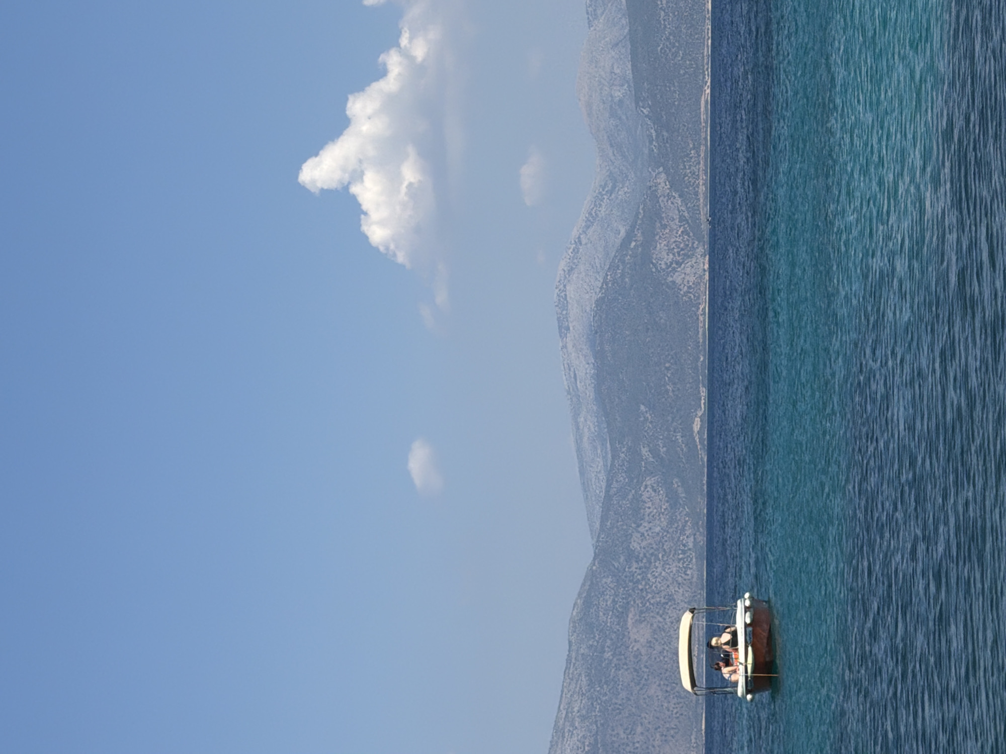 Calm turquoise waters along Kastos Island's rocky coastline
