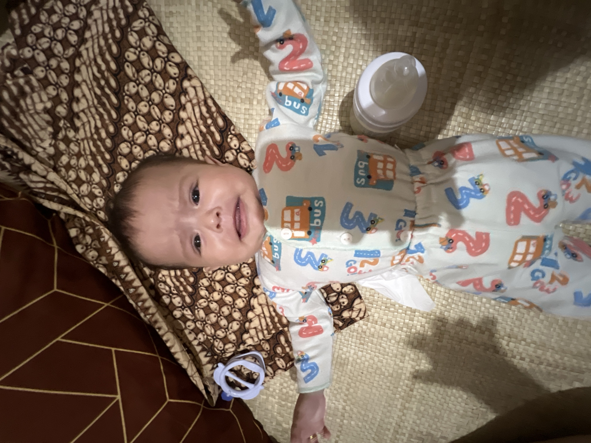 Baby on a mat in Lhokseumawe, moments apart