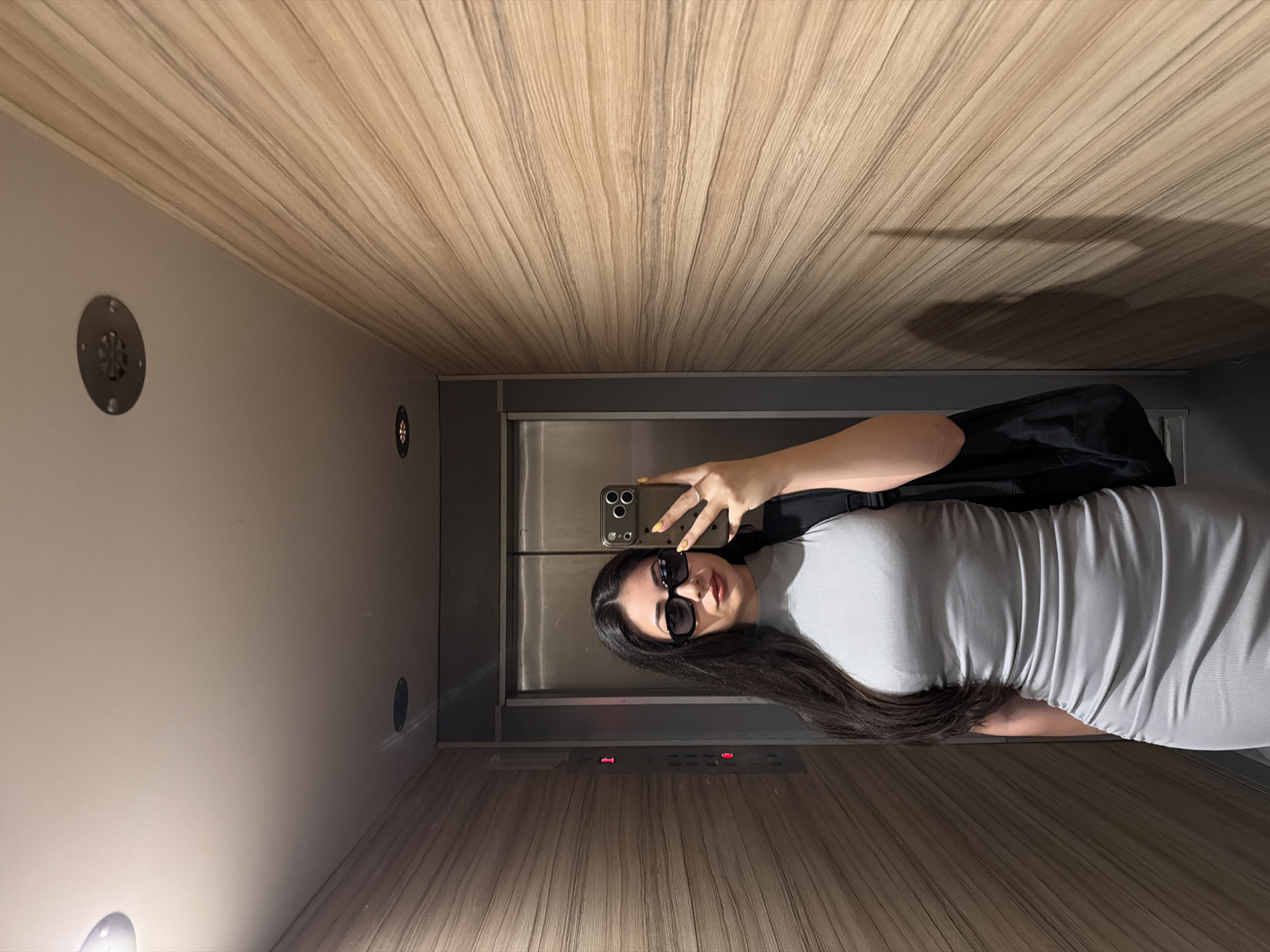 Woman takes elevator selfie as Sofia skyline photographed under clear skies