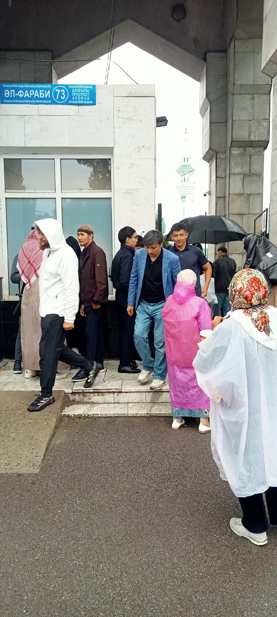 Rainy morning gathering at Almaty's Central Mosque