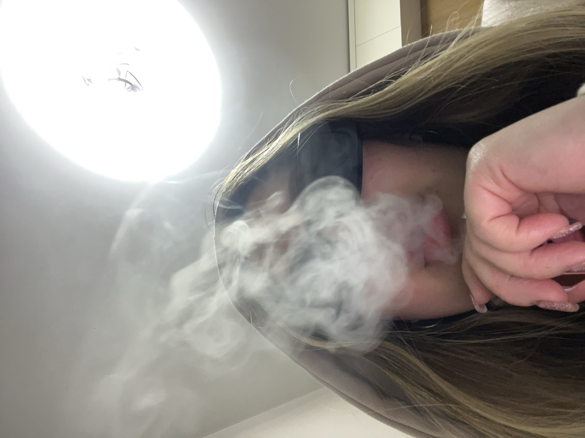Young woman photographed vaping in Krasnodar evening