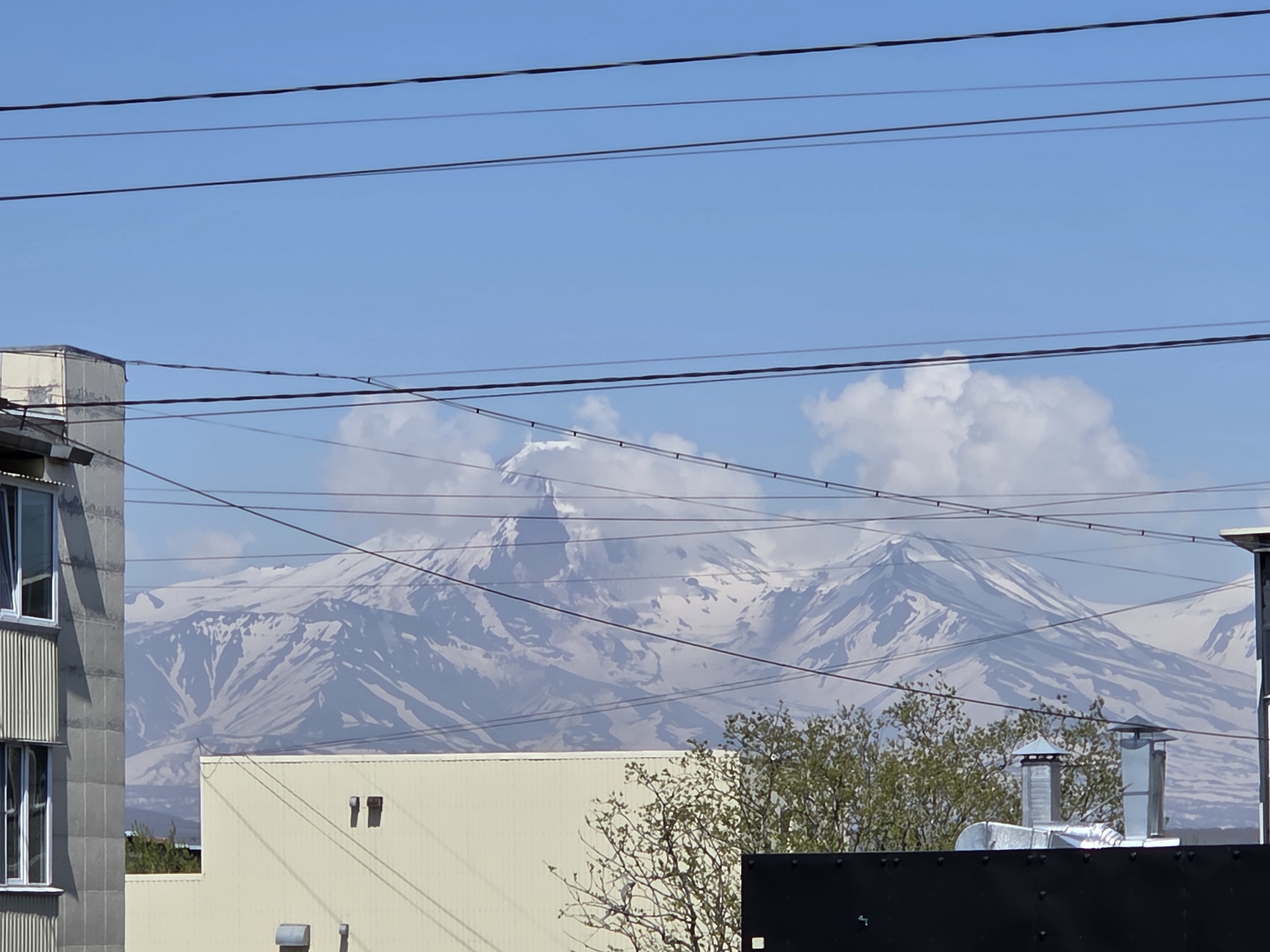 Early morning urban scenes documented across mountain-backdrop city