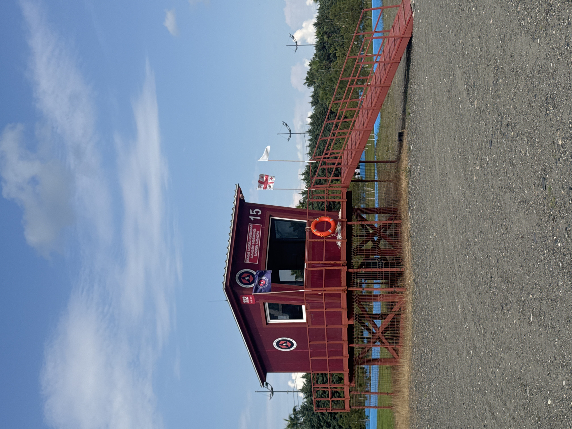 Red lifeguard station on stilts at Anaklia's pebble beach