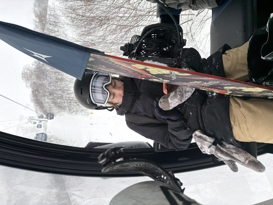 Snowboarder rides morning lift in Kutchan, Japan