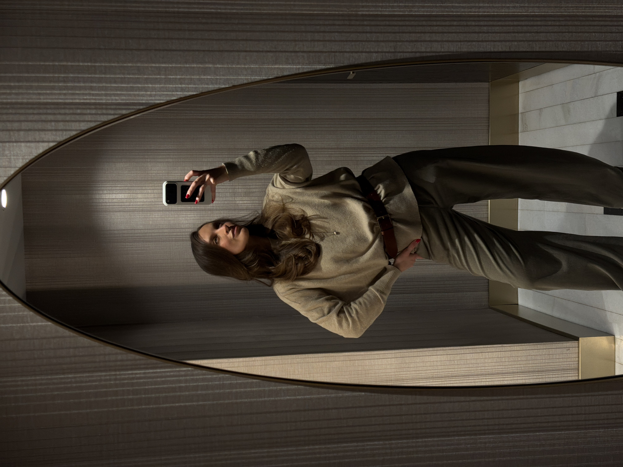 Woman takes mirror selfies in Budva bathroom